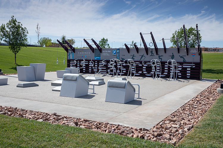 A group of white chairs in a circle on a stone surface.