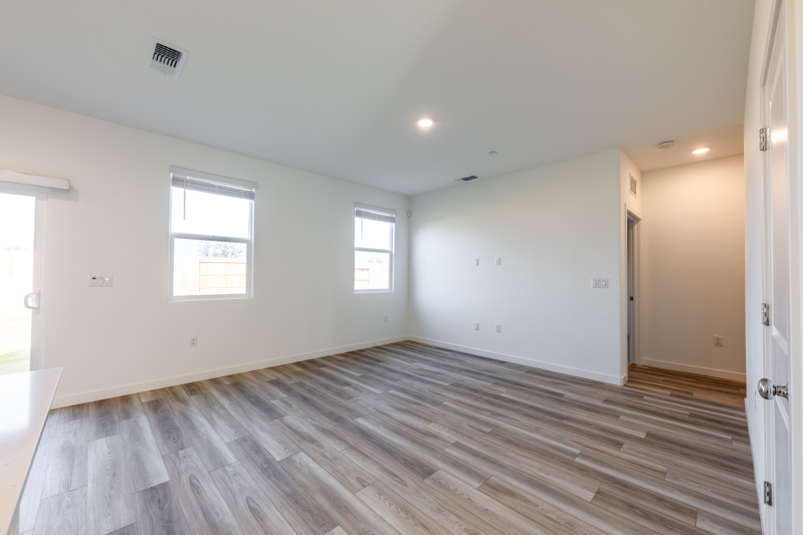 A room with a wood floor and windows.