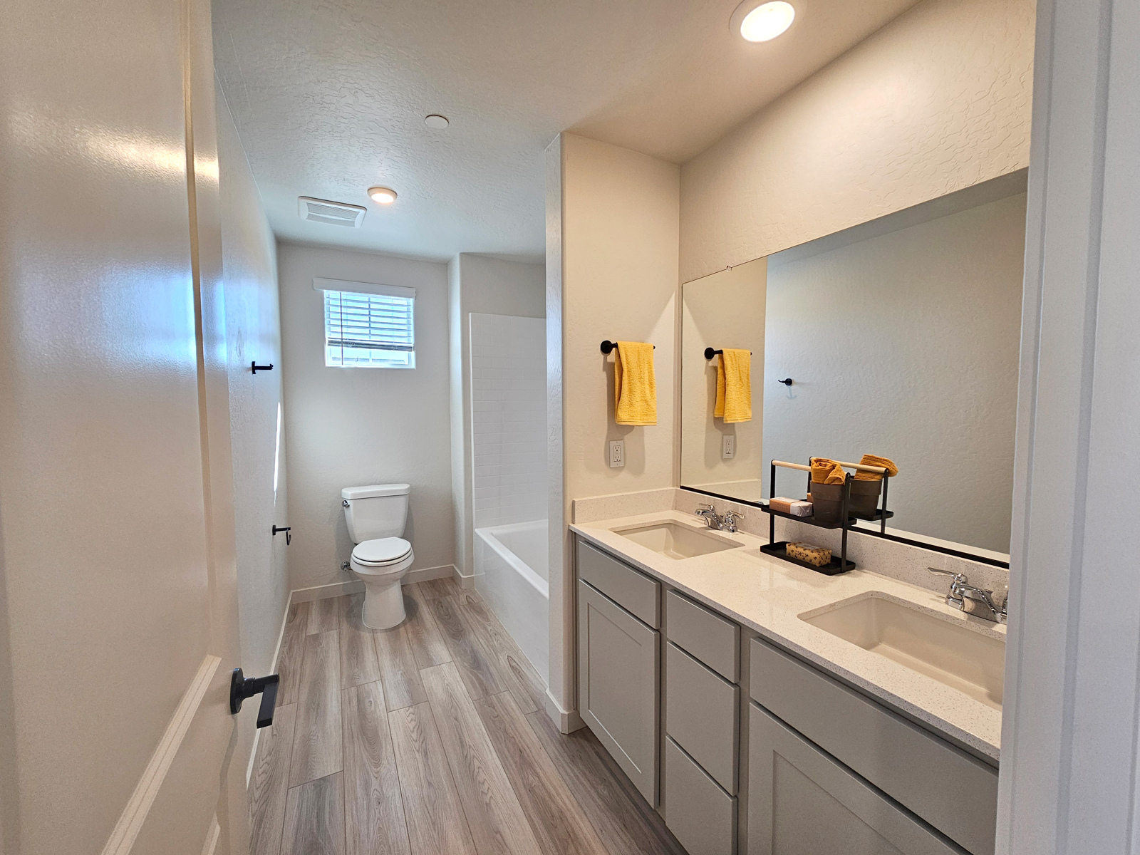 A bathroom with a tub sink and toilet.