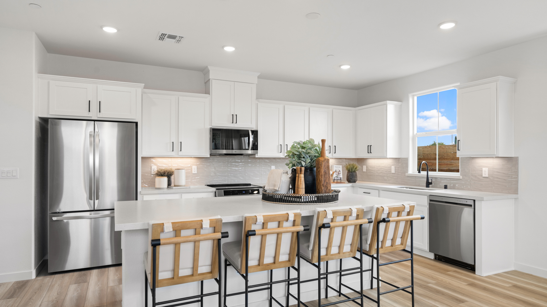 A kitchen with white cabinets.