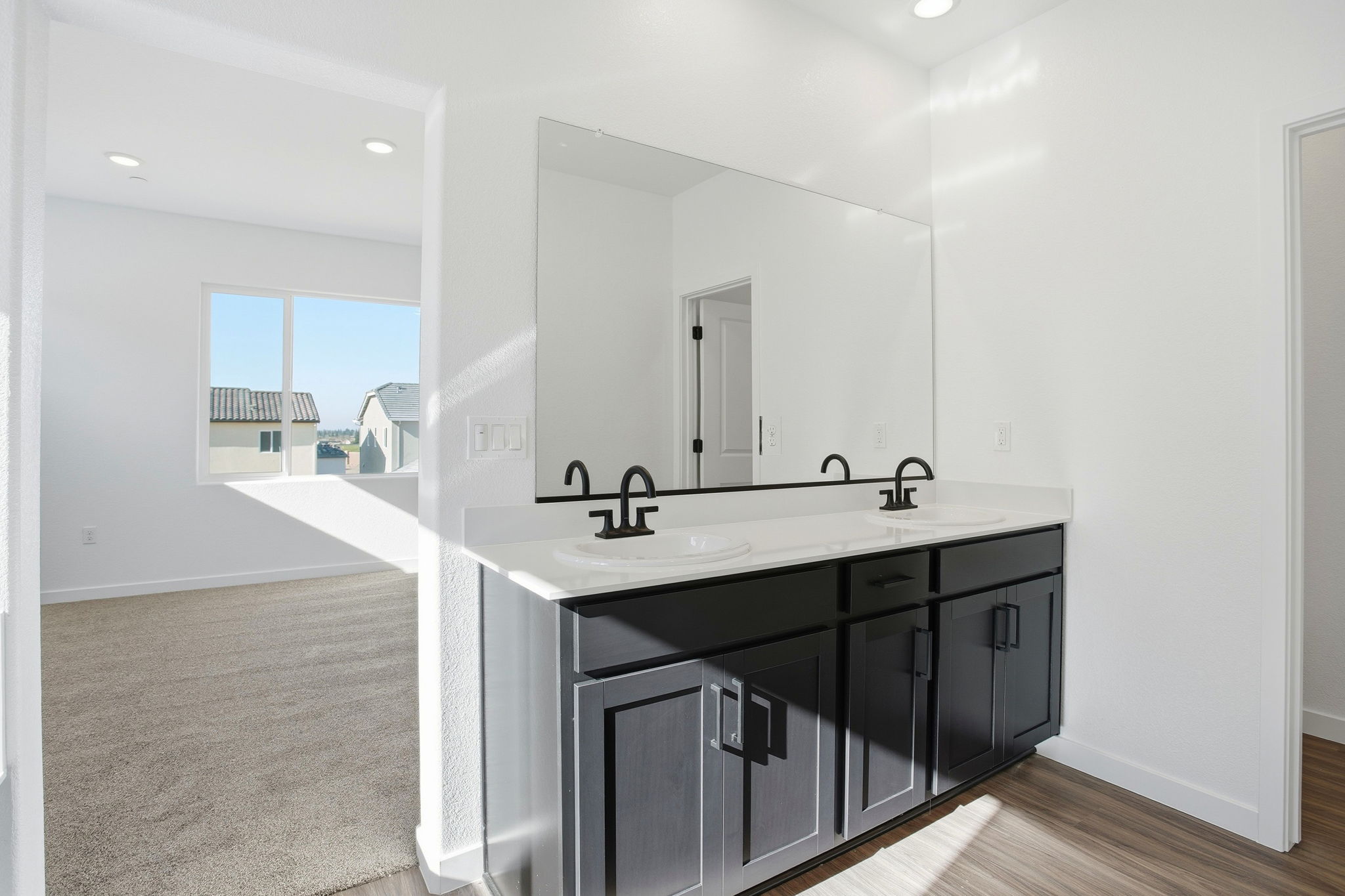 A bathroom with a large mirror.