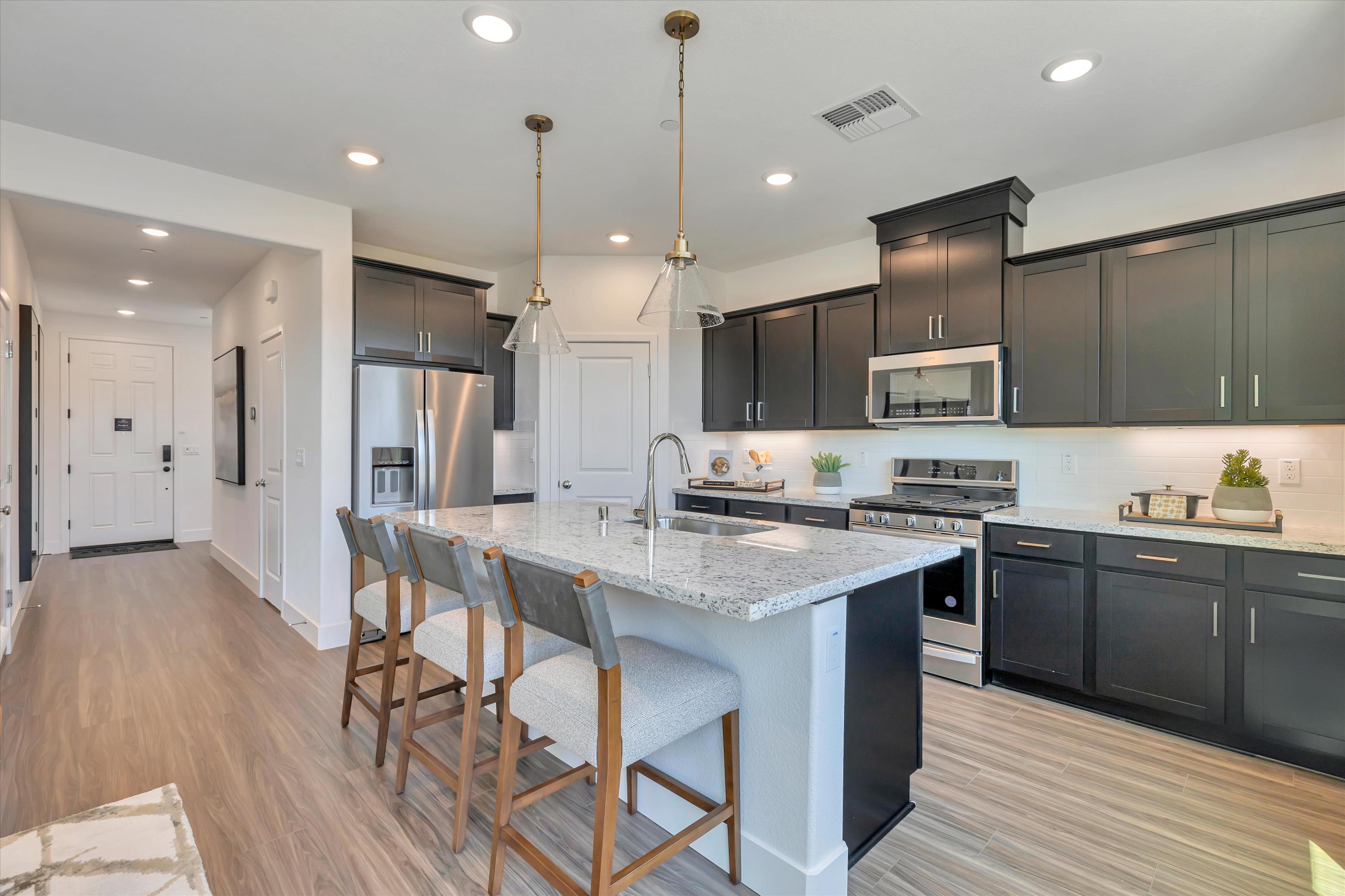 A kitchen with black cabinets.