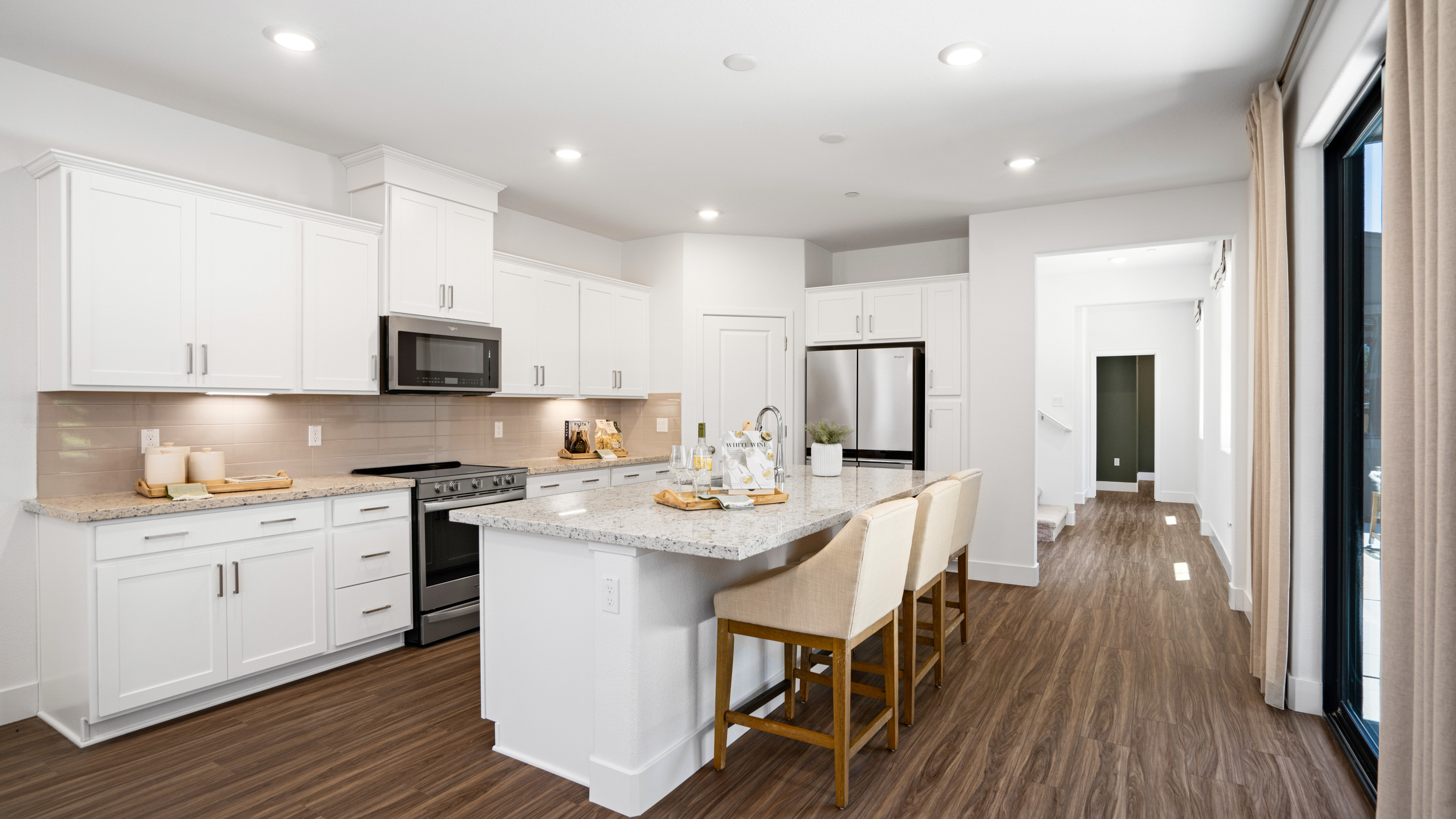A kitchen with white cabinets.