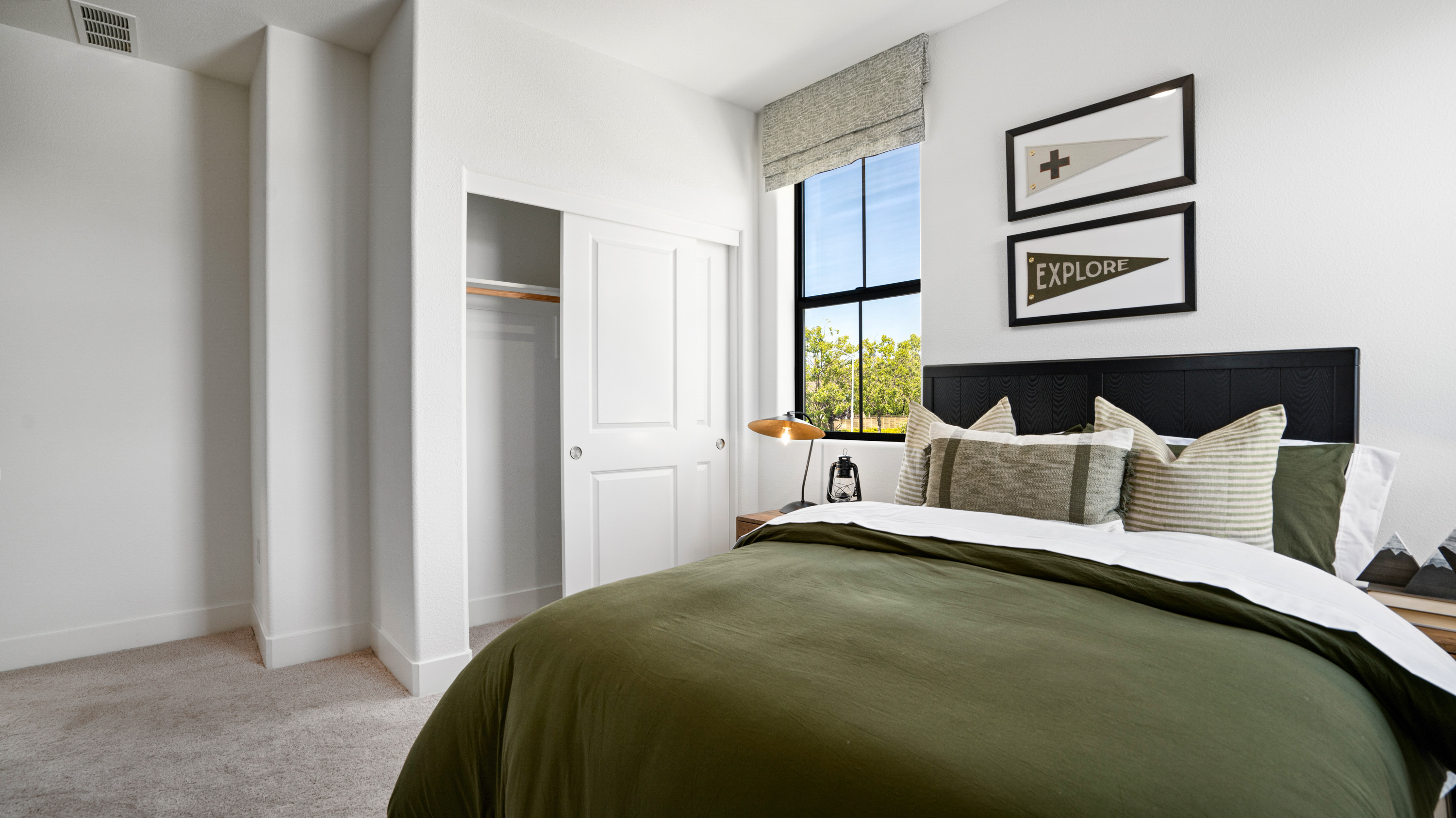 A bedroom with a bed and a window.