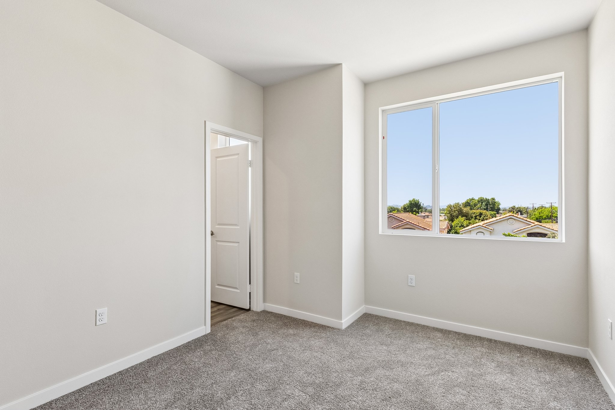 A room with a window and a door.