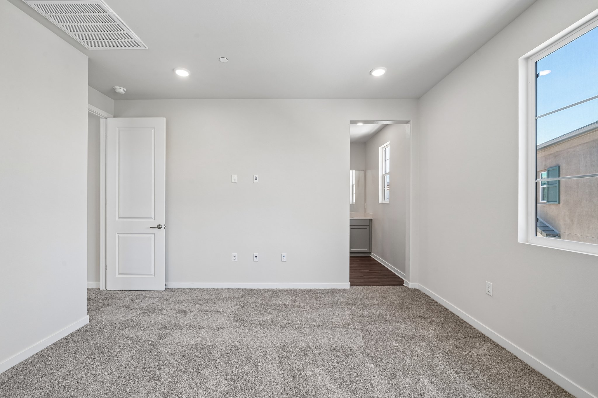 A room with white walls and a window.