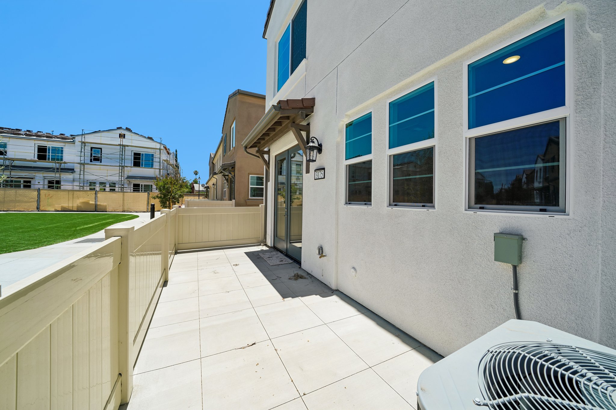 A white building with a walkway.