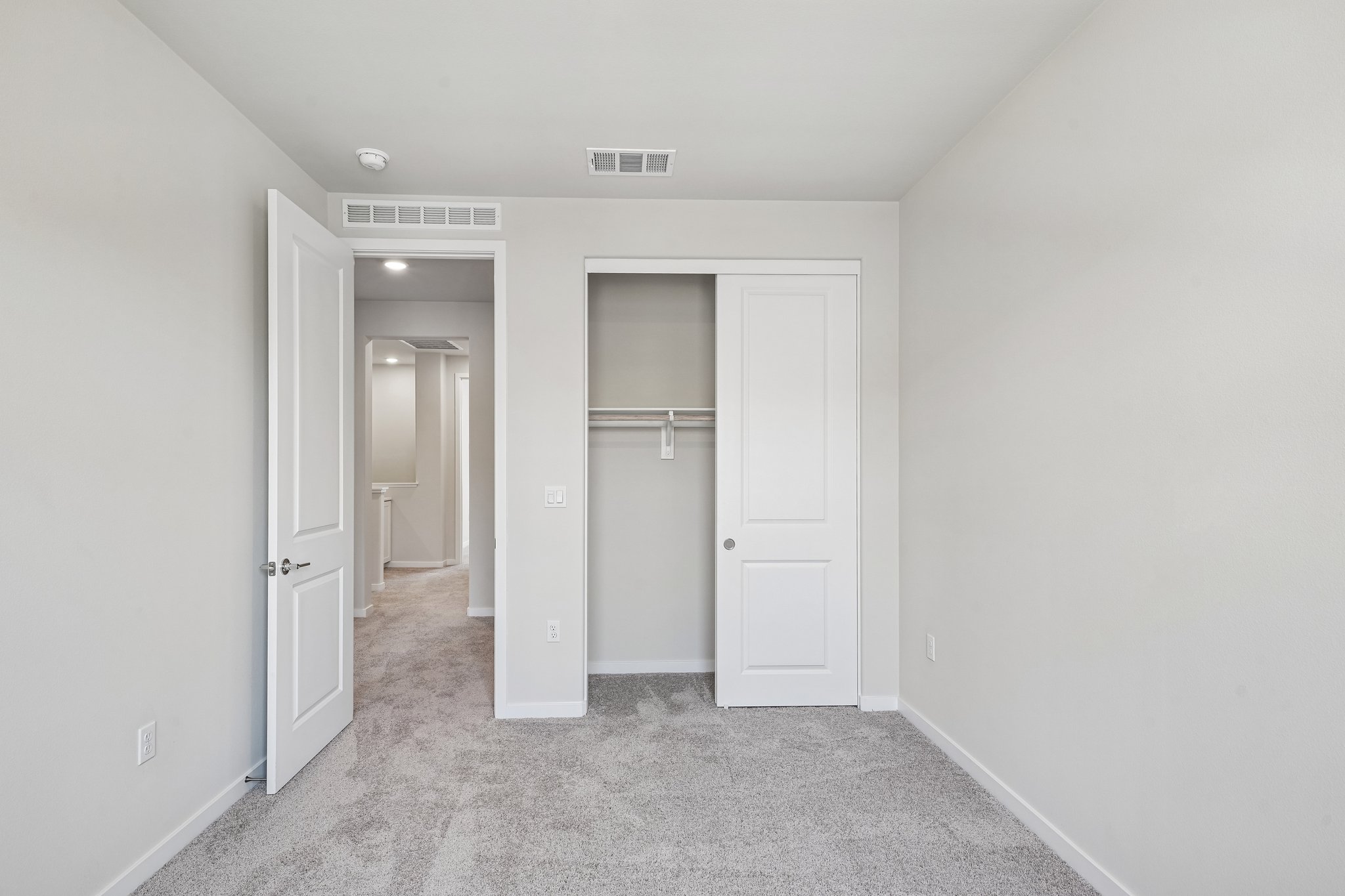 A hallway with white doors.