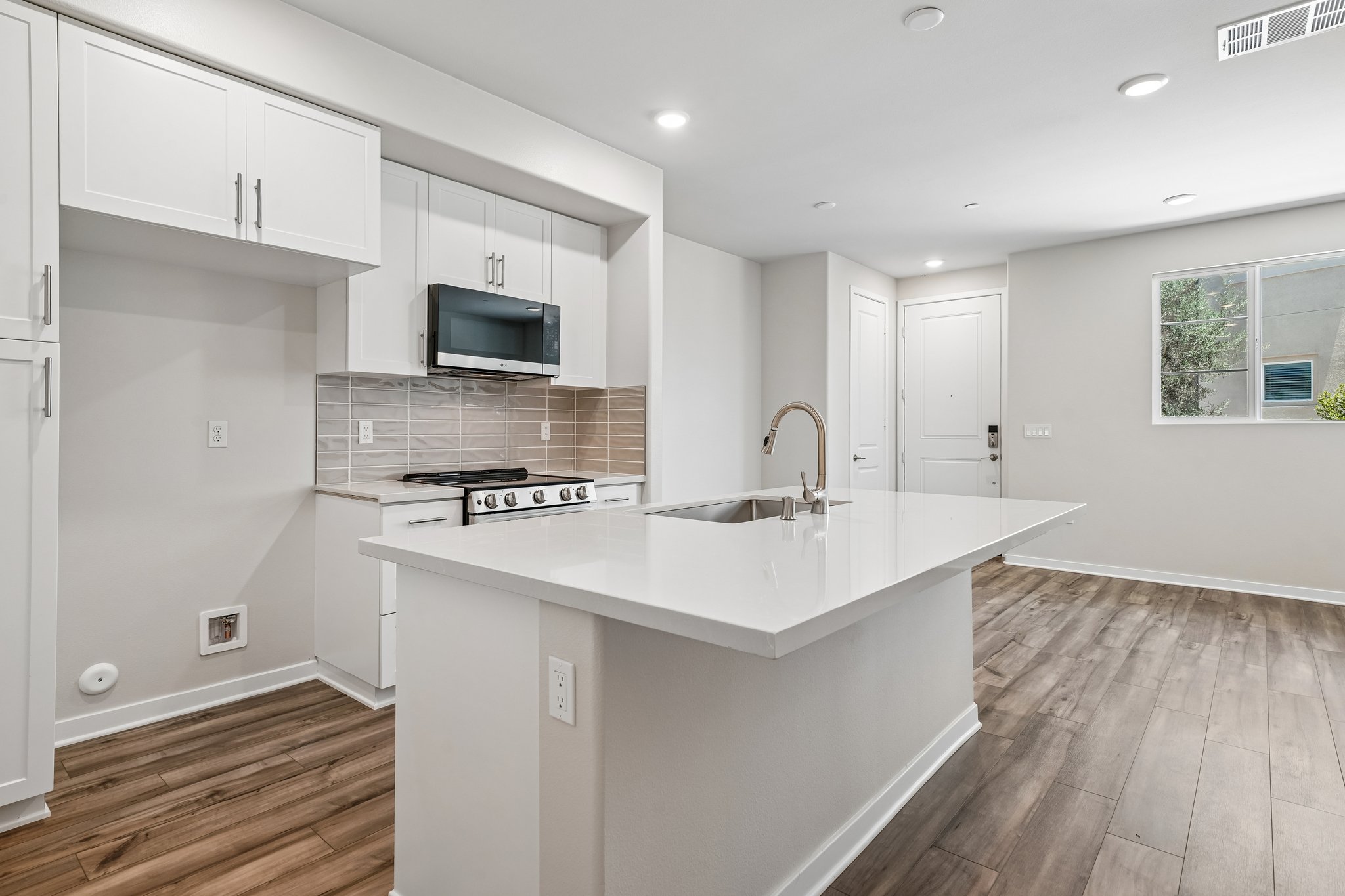 A kitchen with white cabinets.