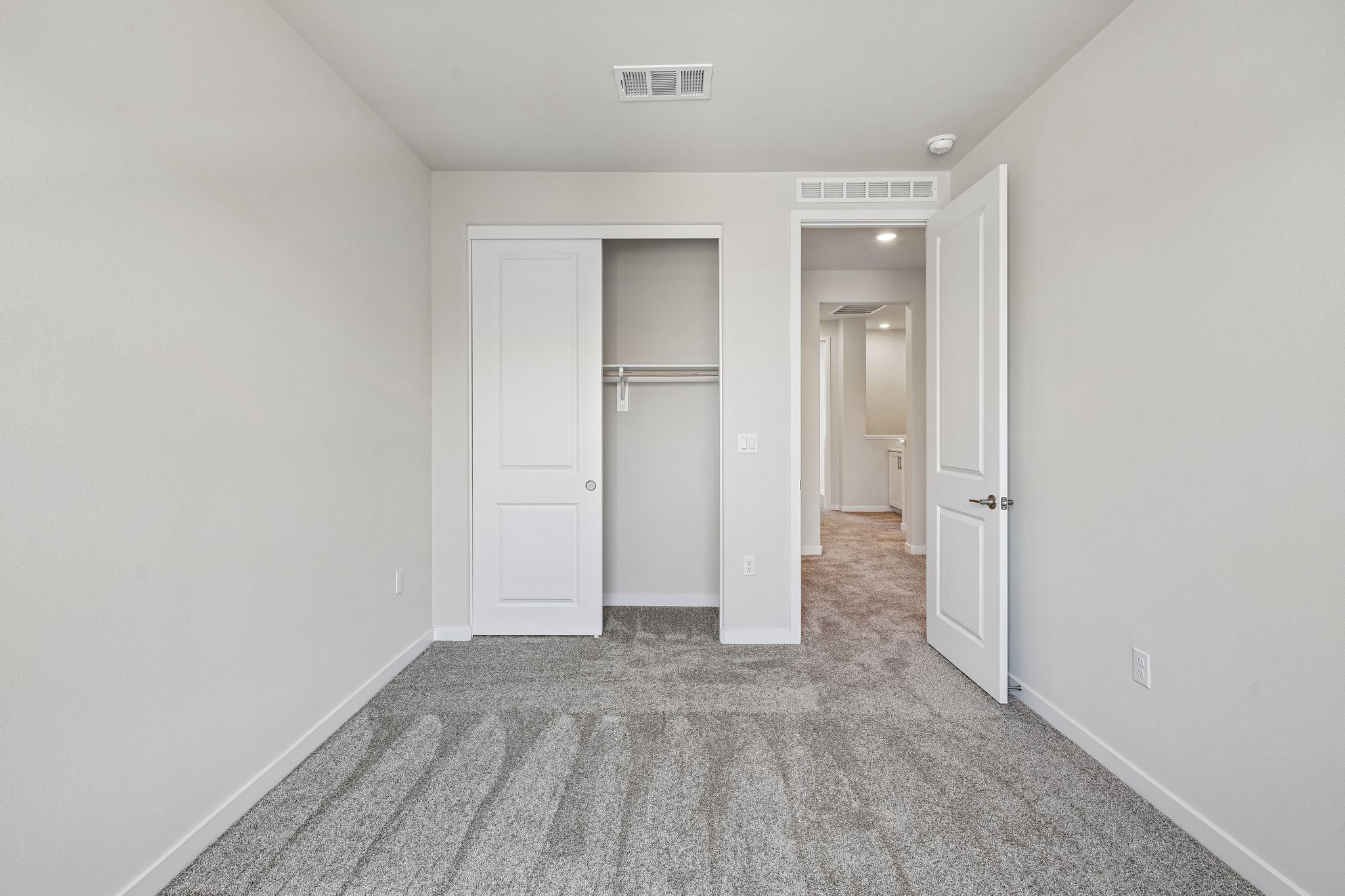 A hallway with white doors.