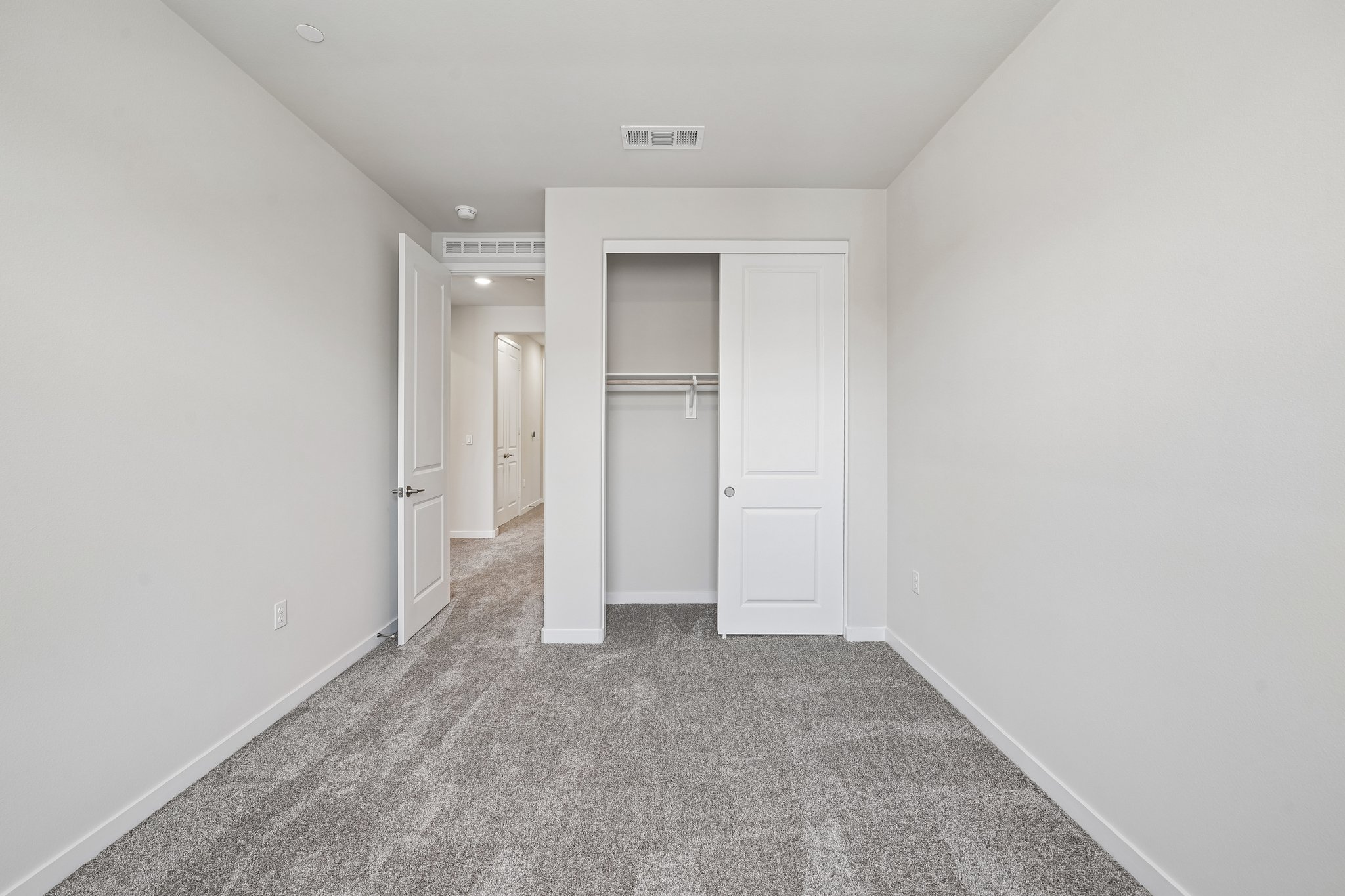 A hallway with white doors.