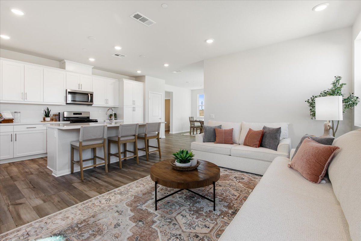A large living room with a large kitchen and dining area.