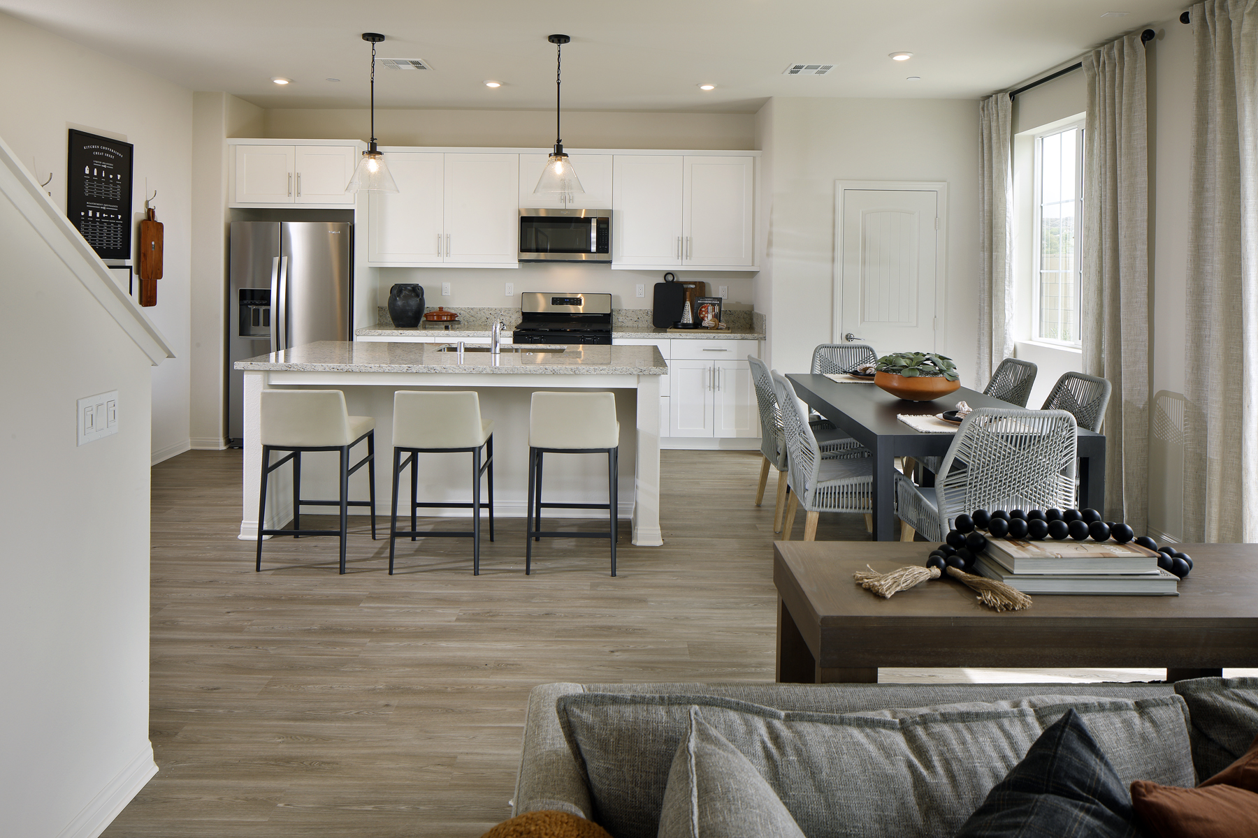 A kitchen with a dining table and chairs.