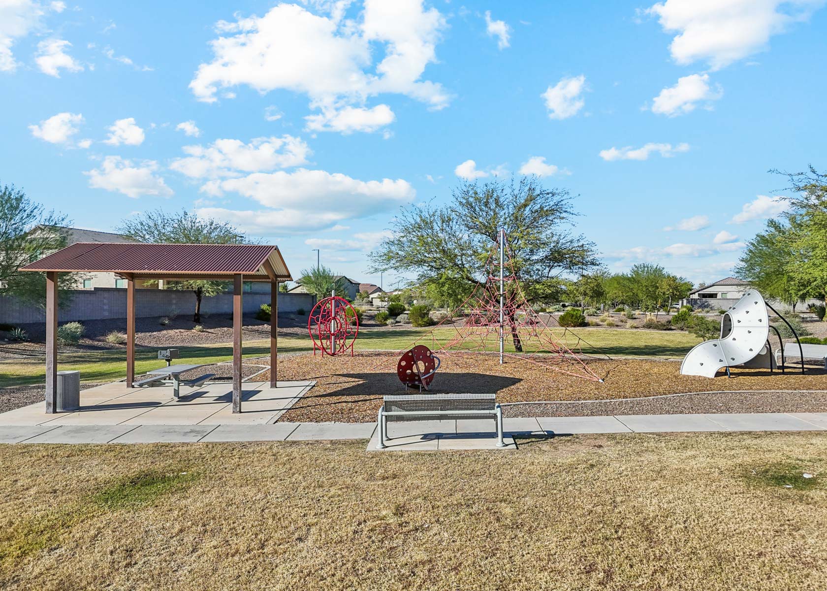 A park with a gazebo and a statue.