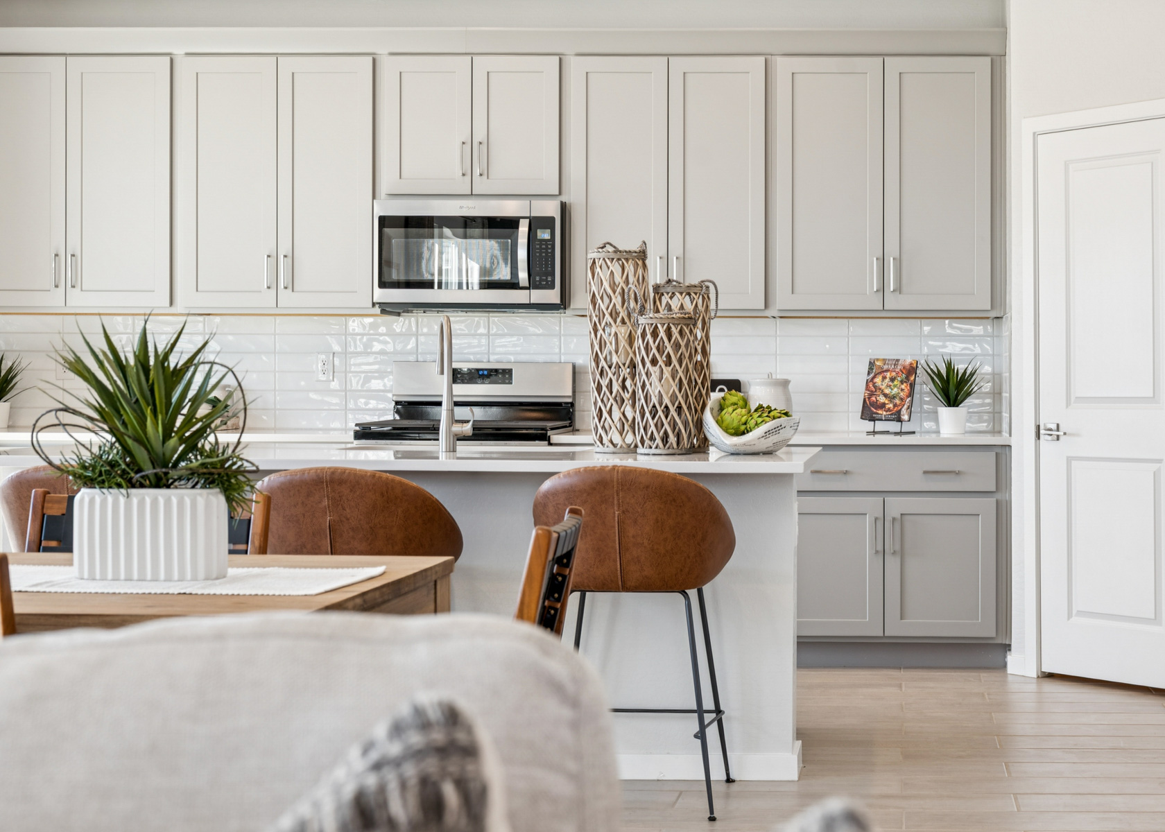 A kitchen with white cabinets.