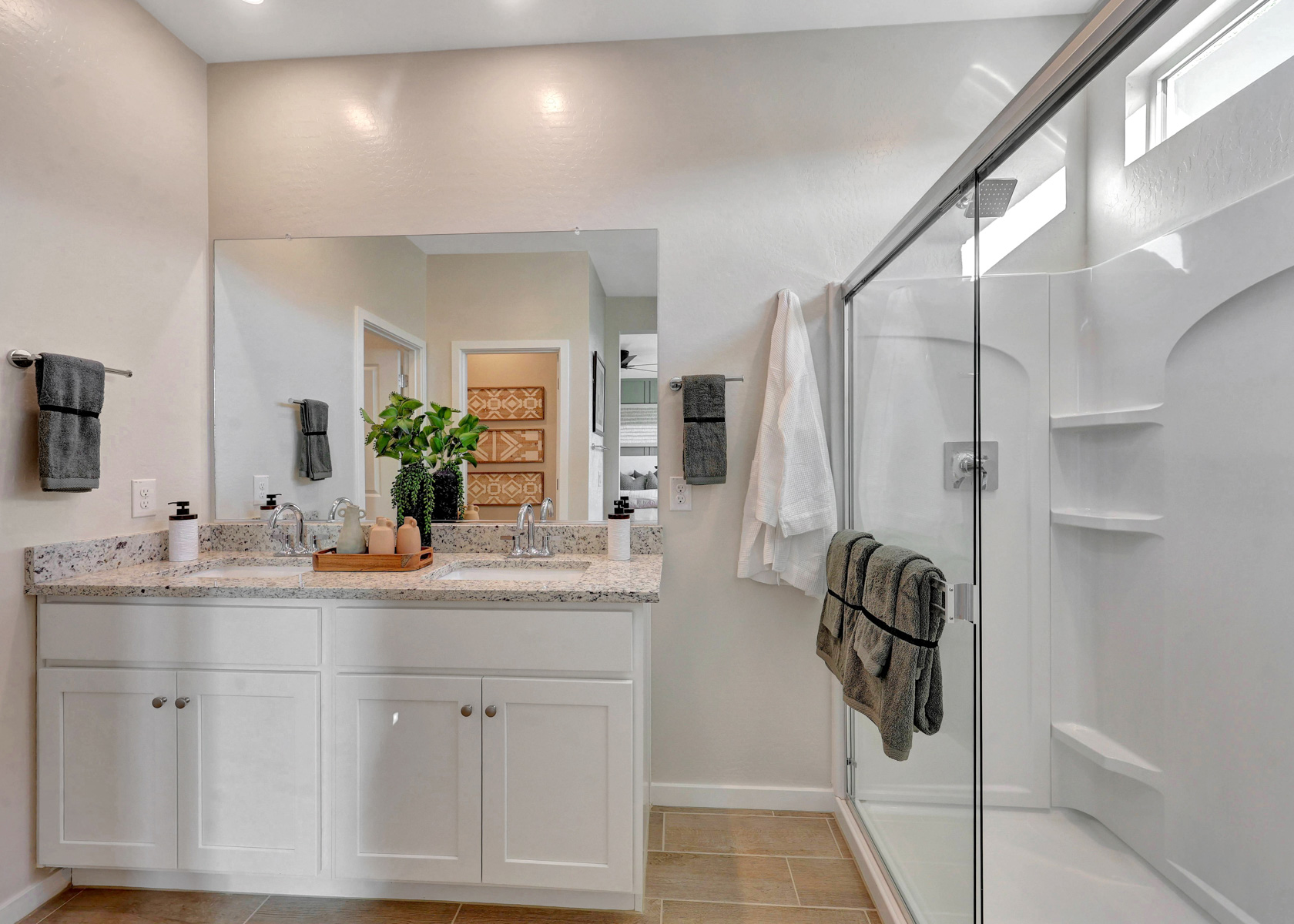 A bathroom with a shower and sink.