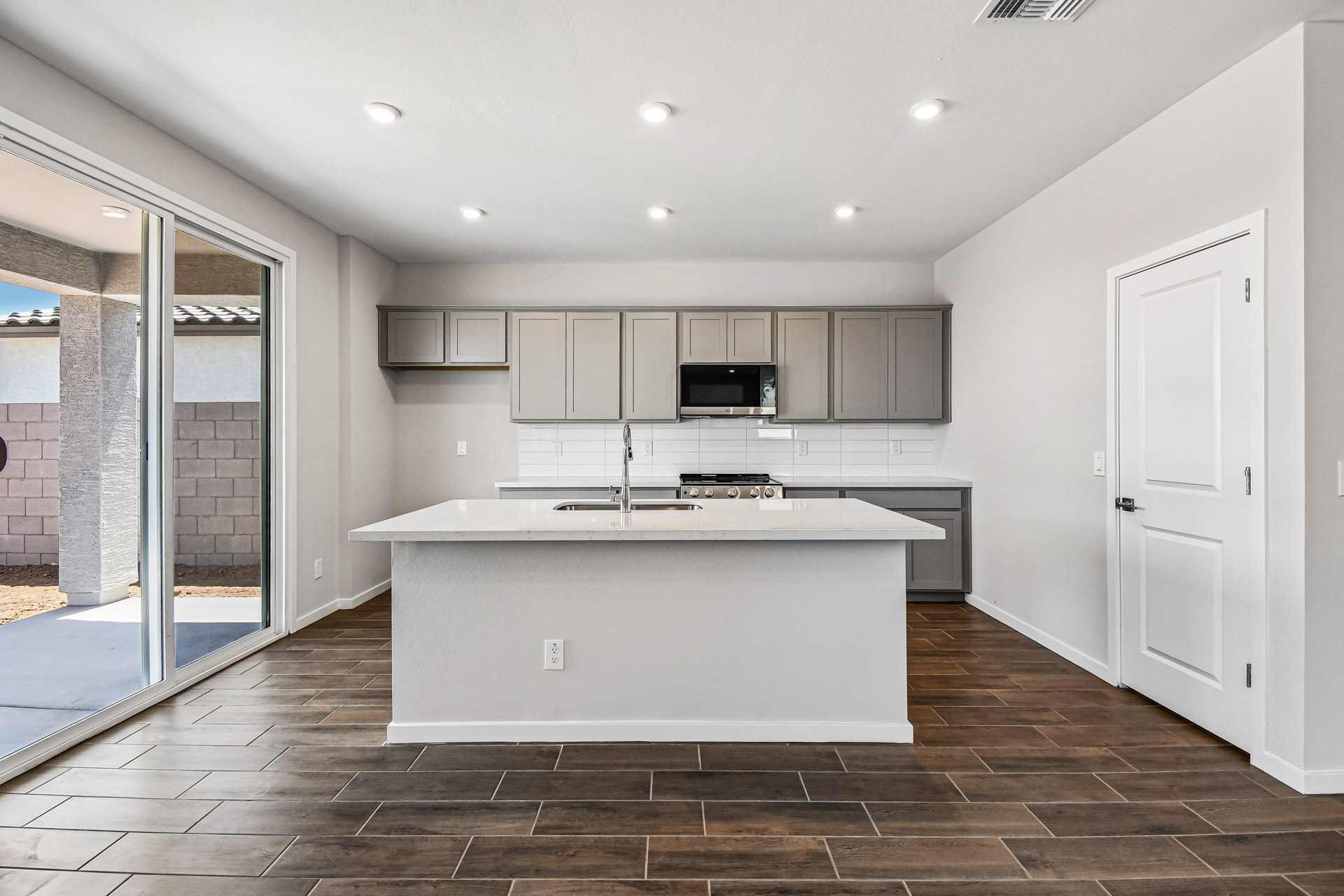 A kitchen with white cabinets.