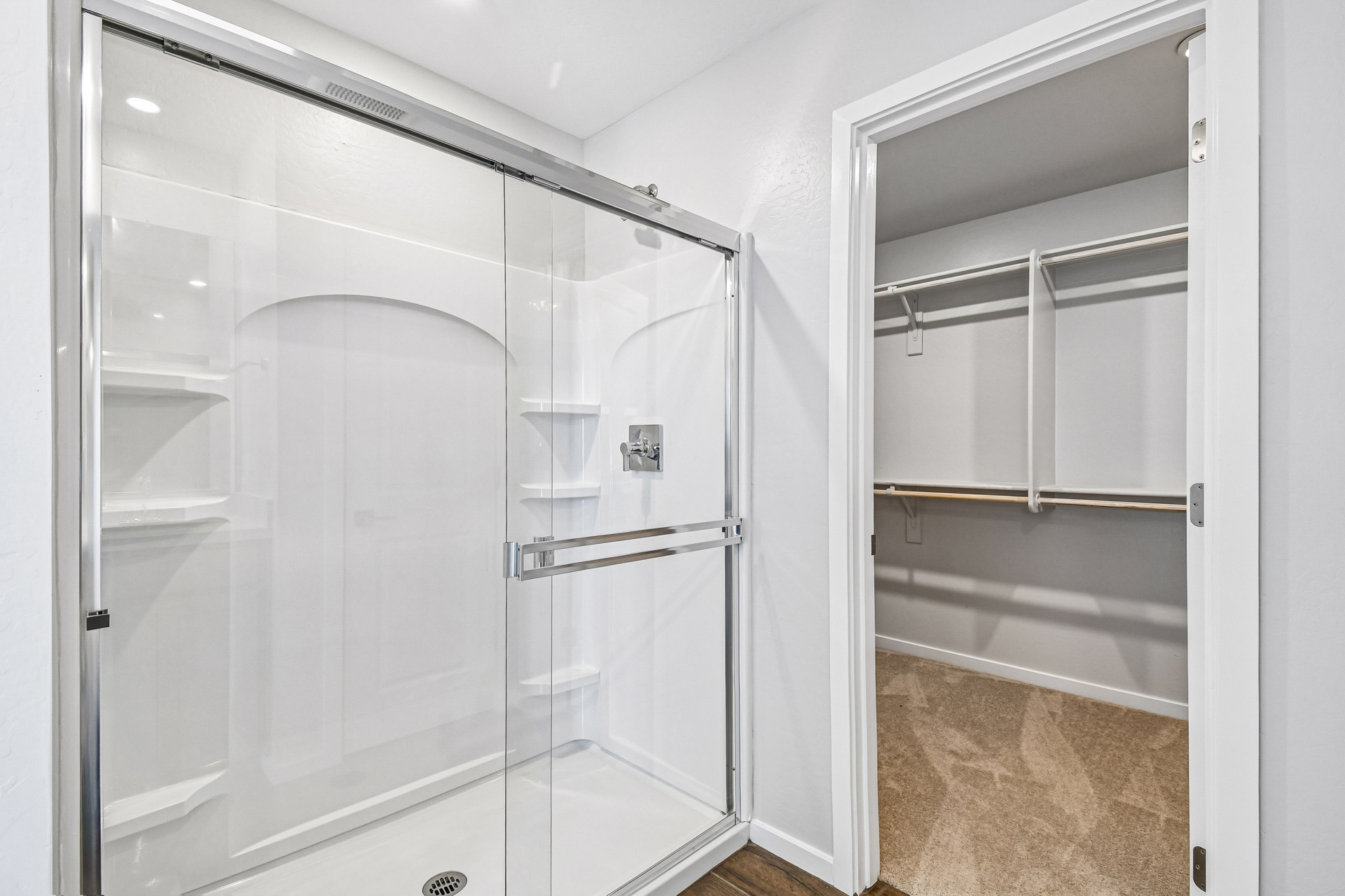 A shower with a glass door.