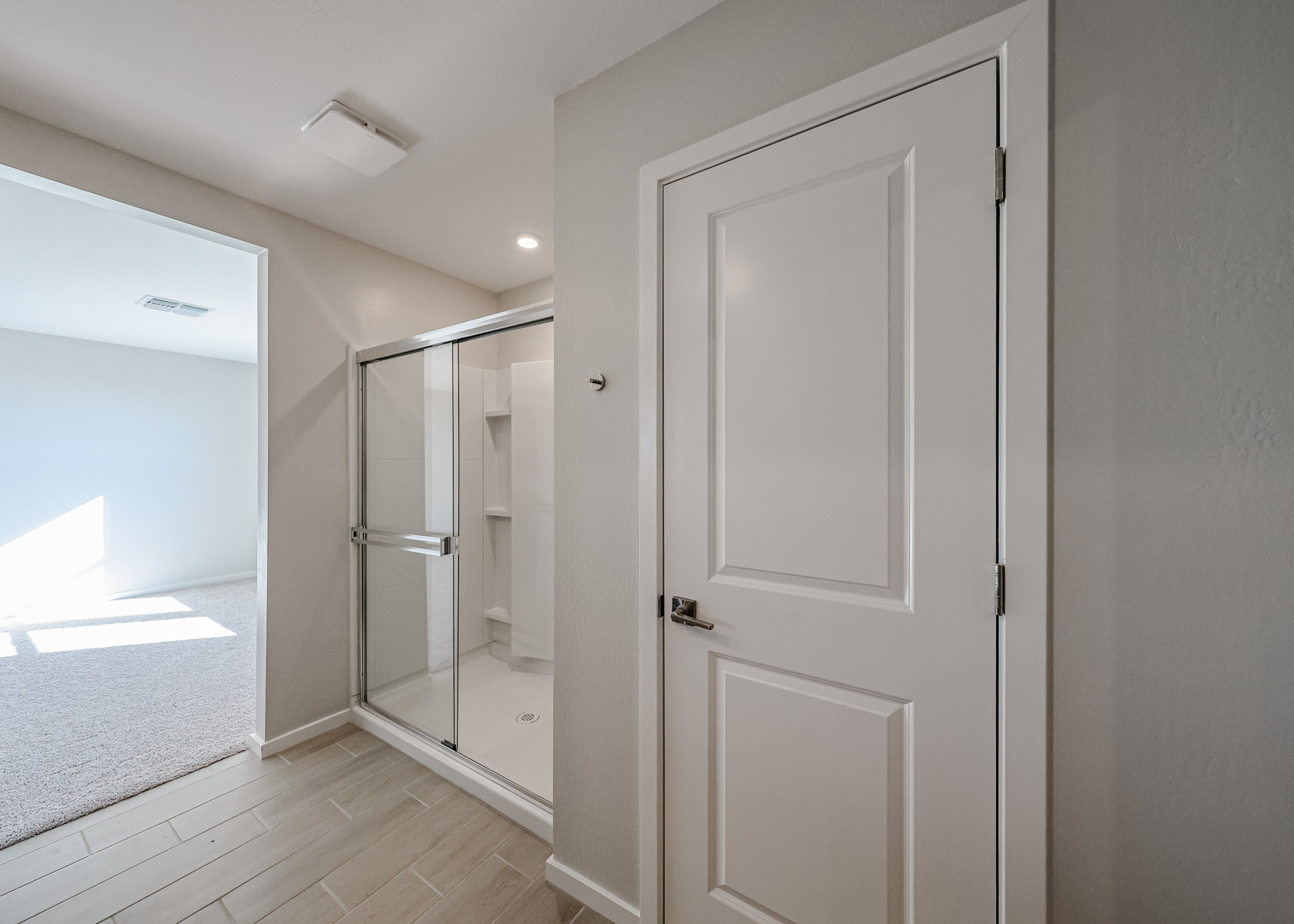 A bathroom with a glass door.