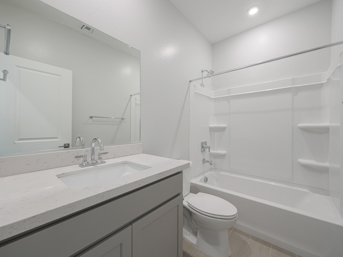 A bathroom with a sink toilet and bathtub.
