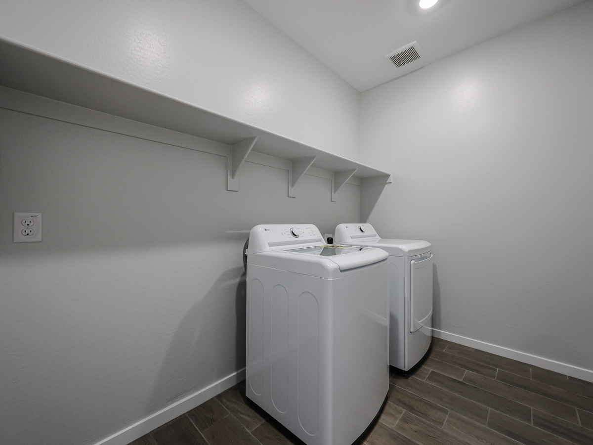 A washing machine in a room.