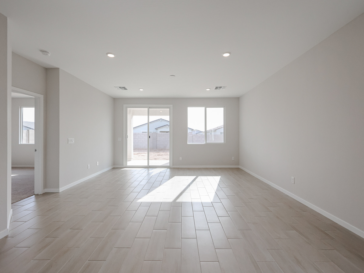 A large empty room with a large glass door.