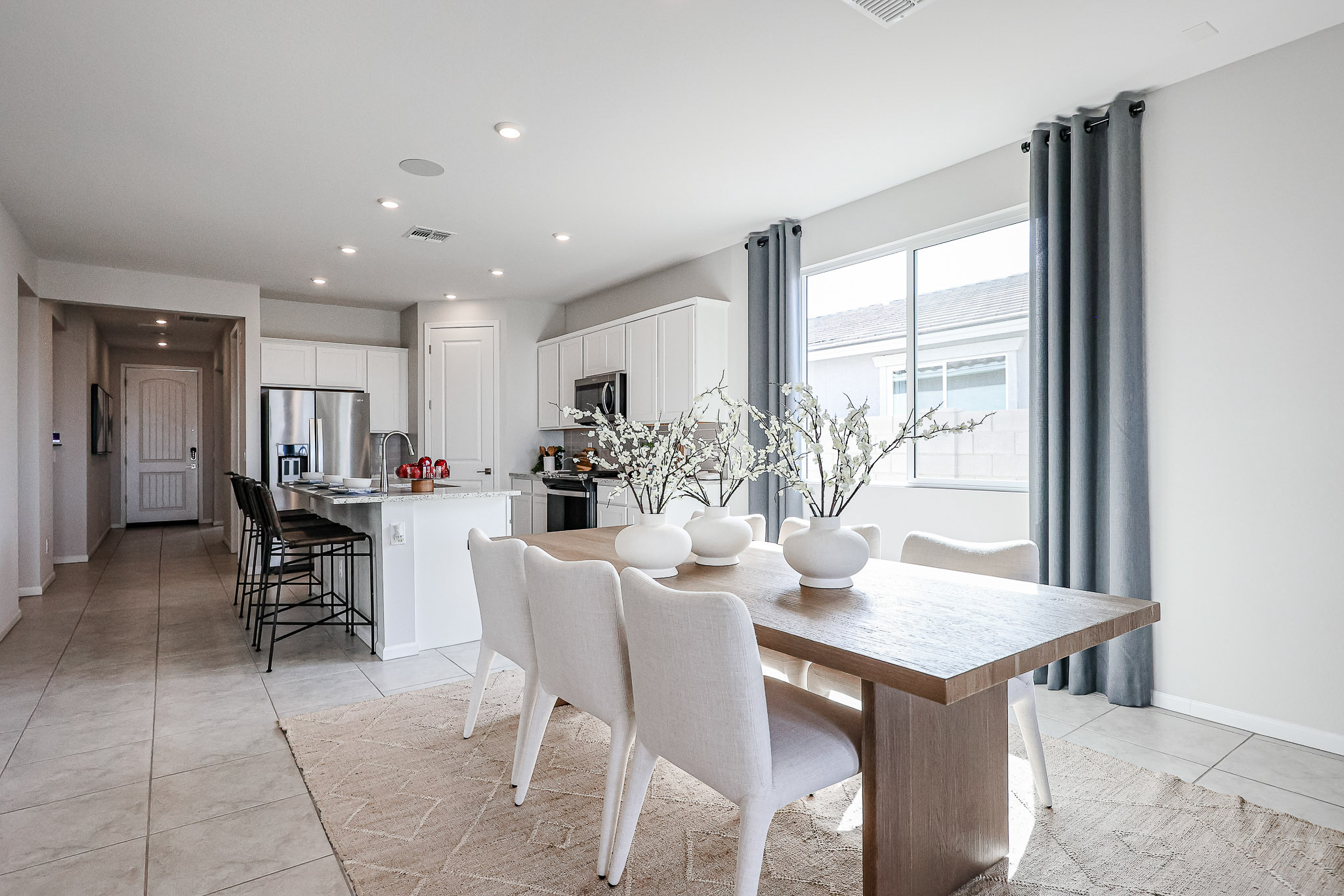 A dining room with a large table.