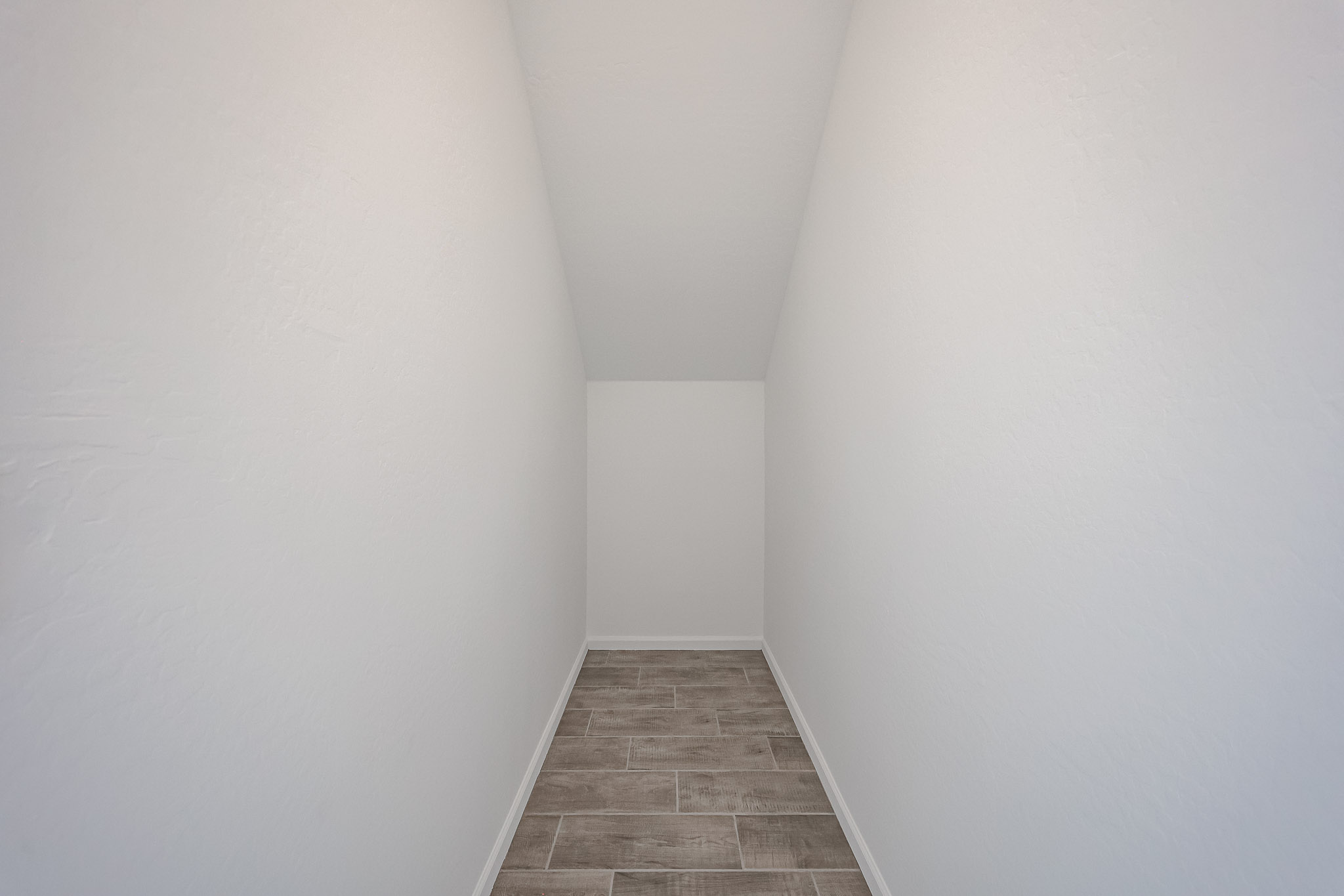 A hallway with white walls.