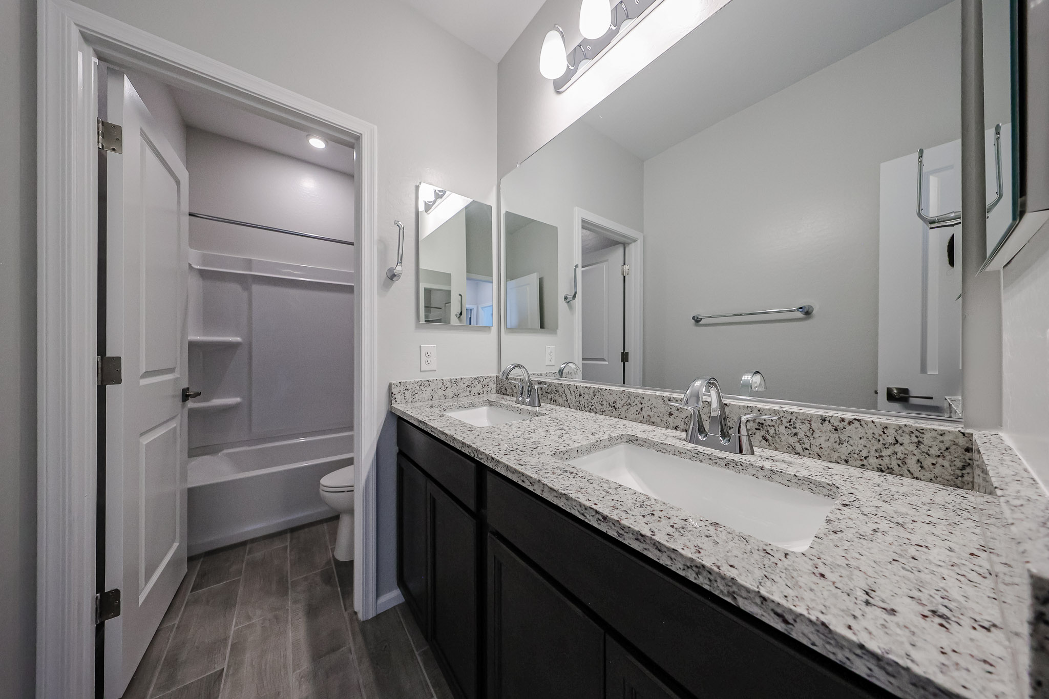 A bathroom with a marble countertop.