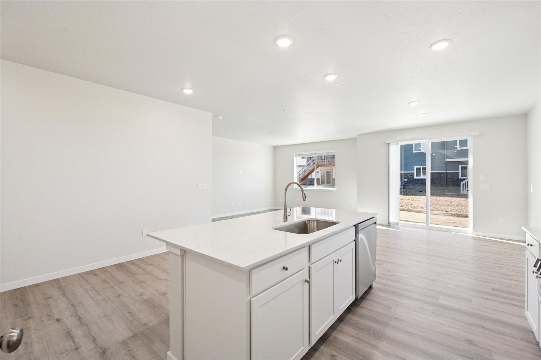 A kitchen with white cabinets.