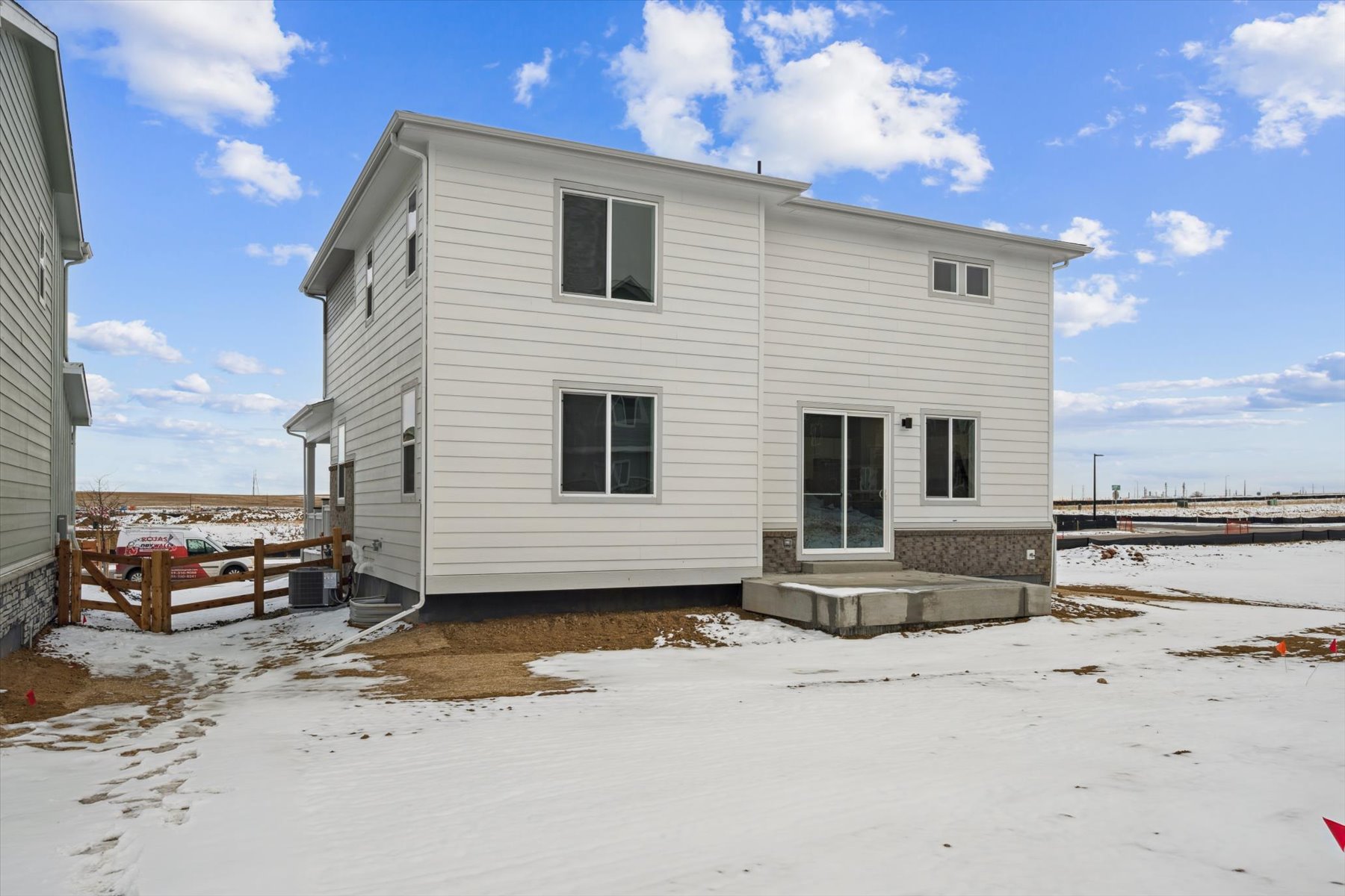 A white house with a fence around it.
