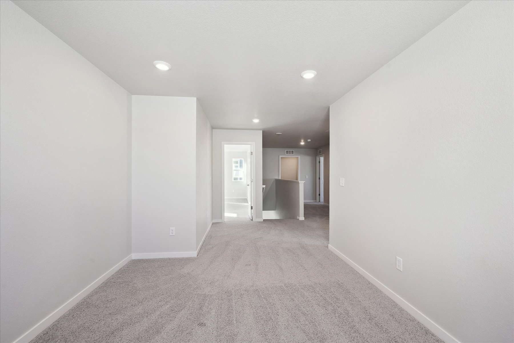 A hallway with white walls.