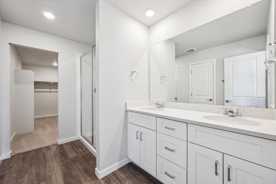 A bathroom with white cabinets.
