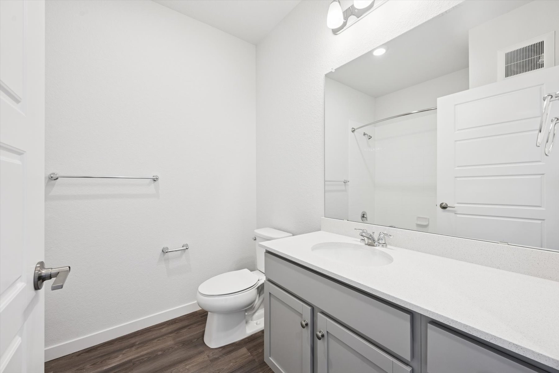 A bathroom with a tub sink and toilet.