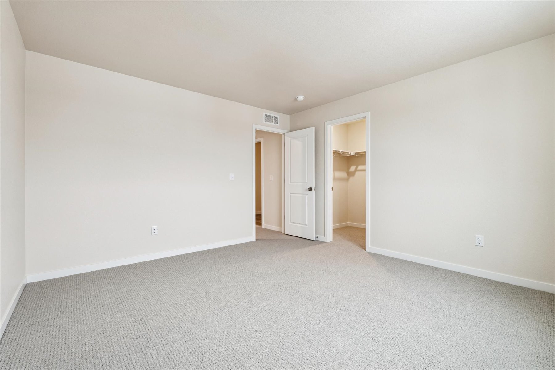 A hallway with white walls.