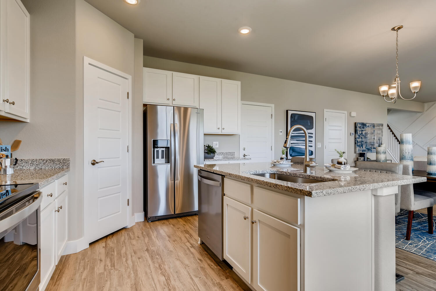 A kitchen with white cabinets.