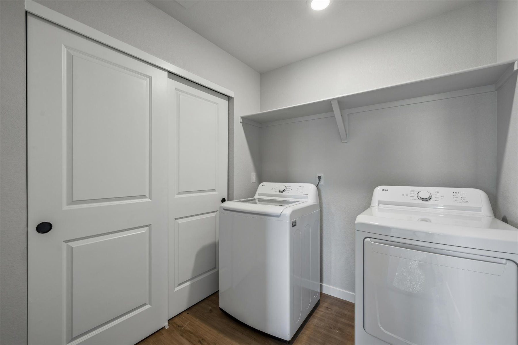 A white laundry room with a washer and dryer.