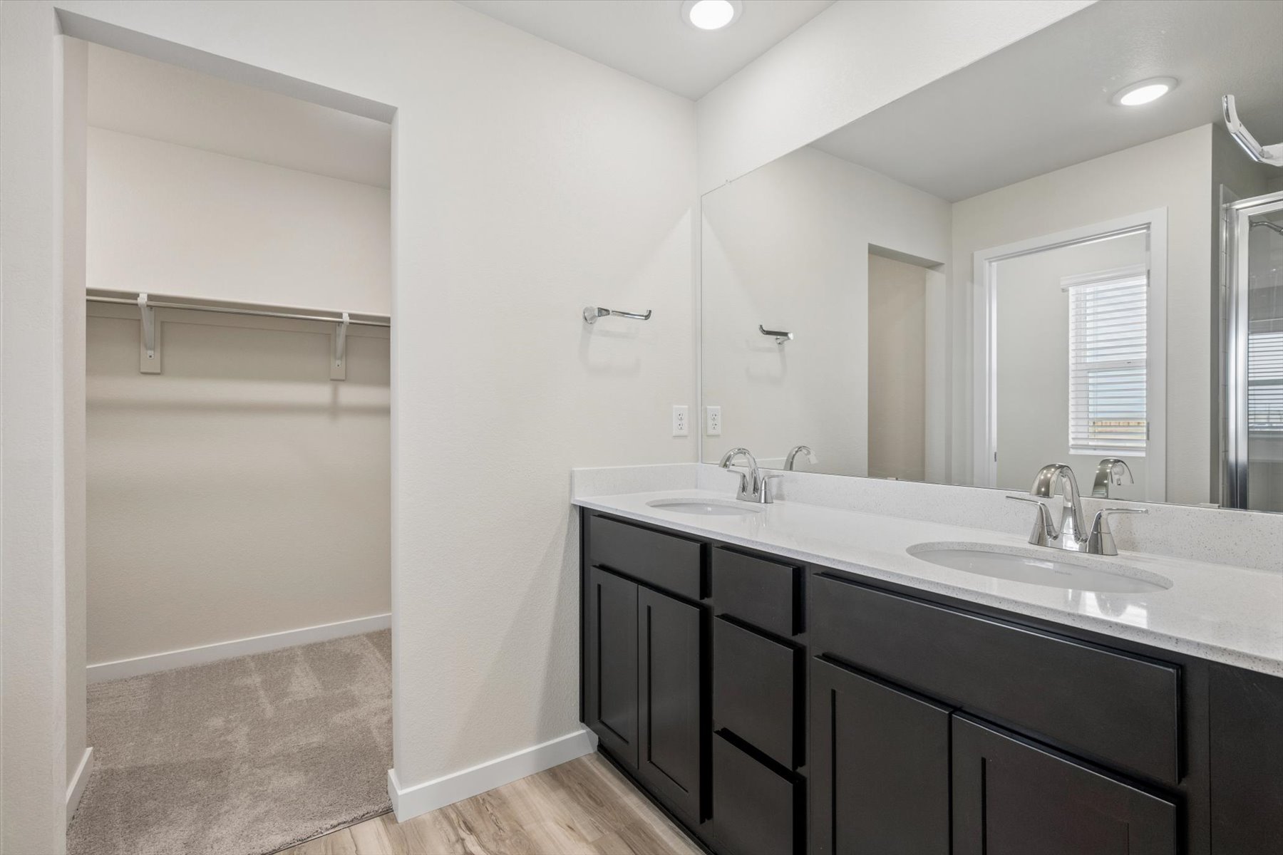 A bathroom with a large mirror.