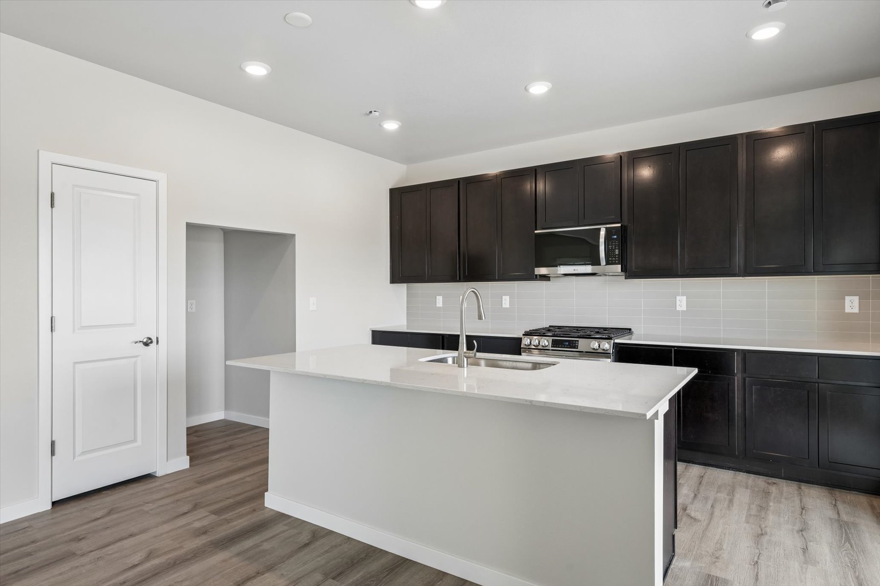 A kitchen with black cabinets.