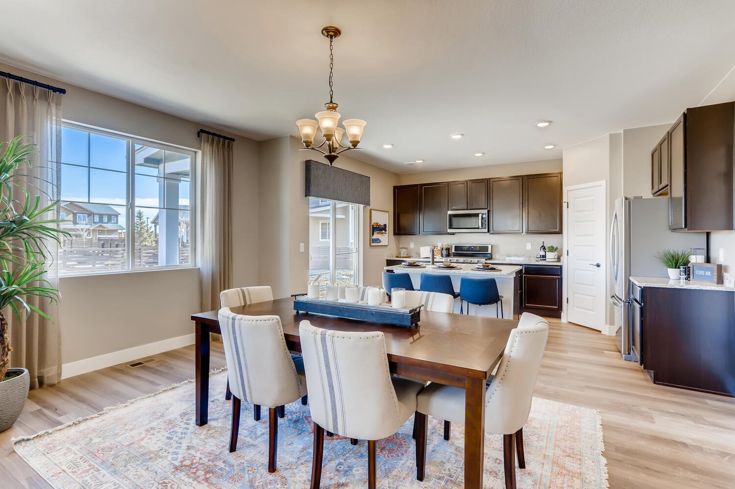 A large kitchen with a dining table.