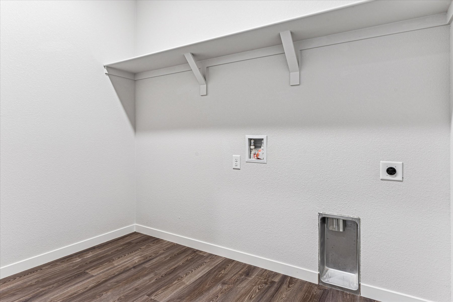 A white wall with a light fixture.