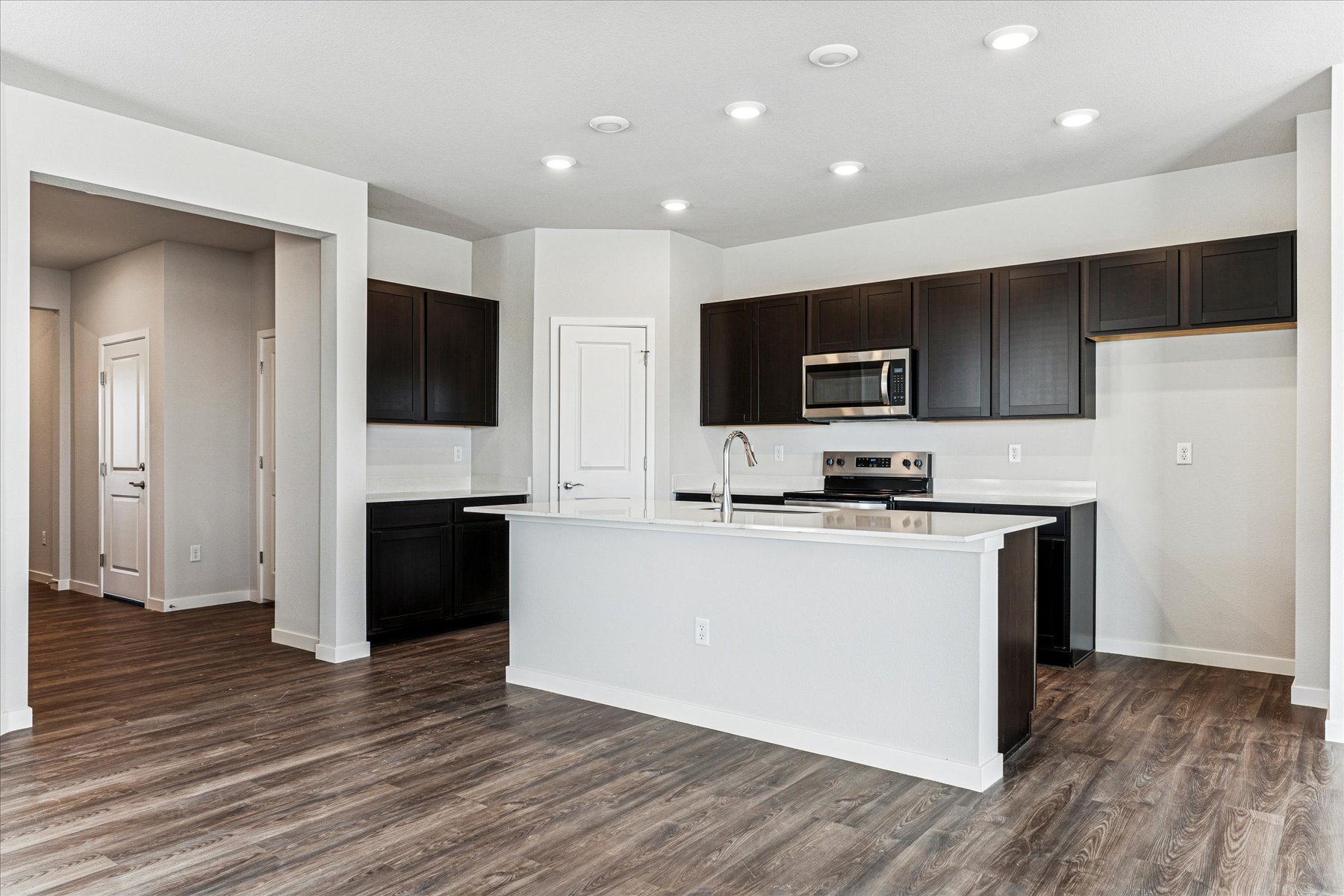 A kitchen with black cabinets.