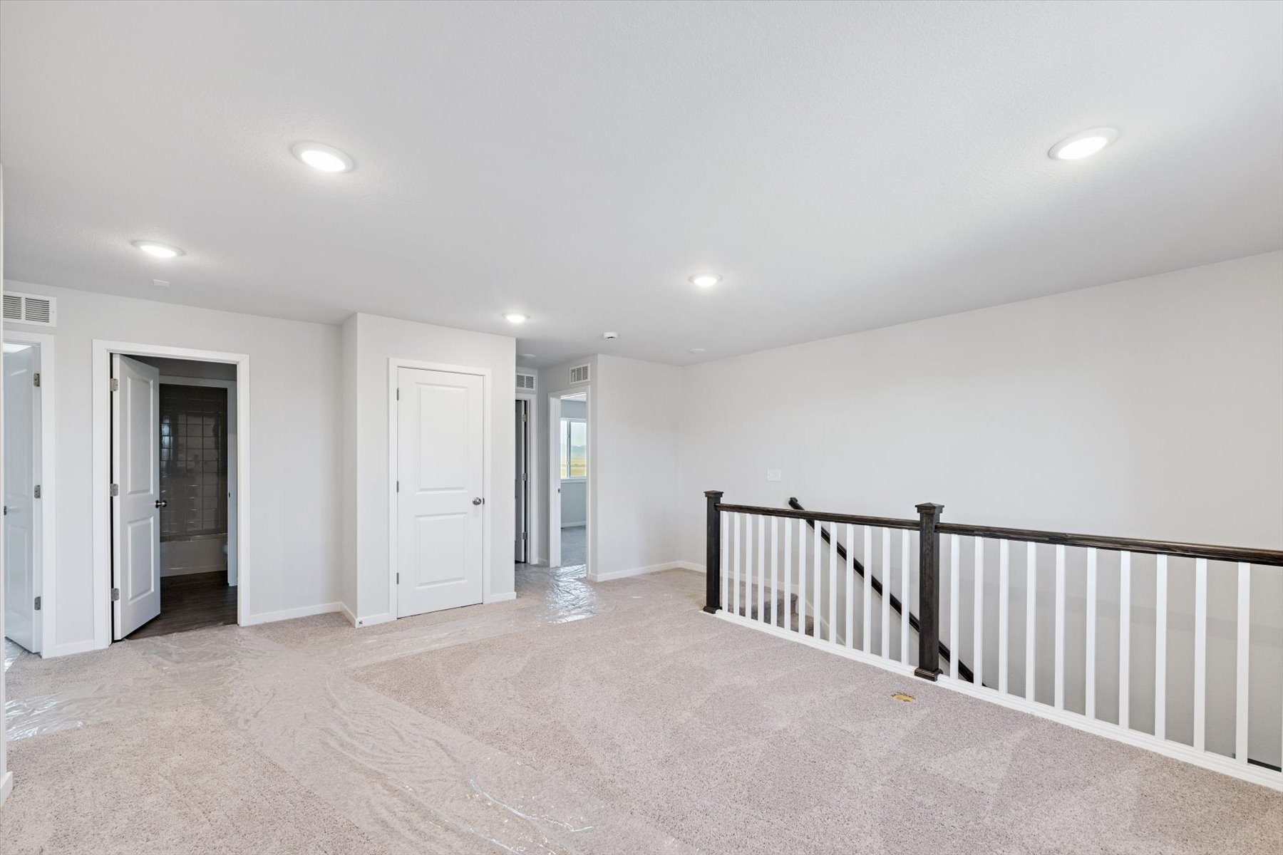 A hallway with white doors.