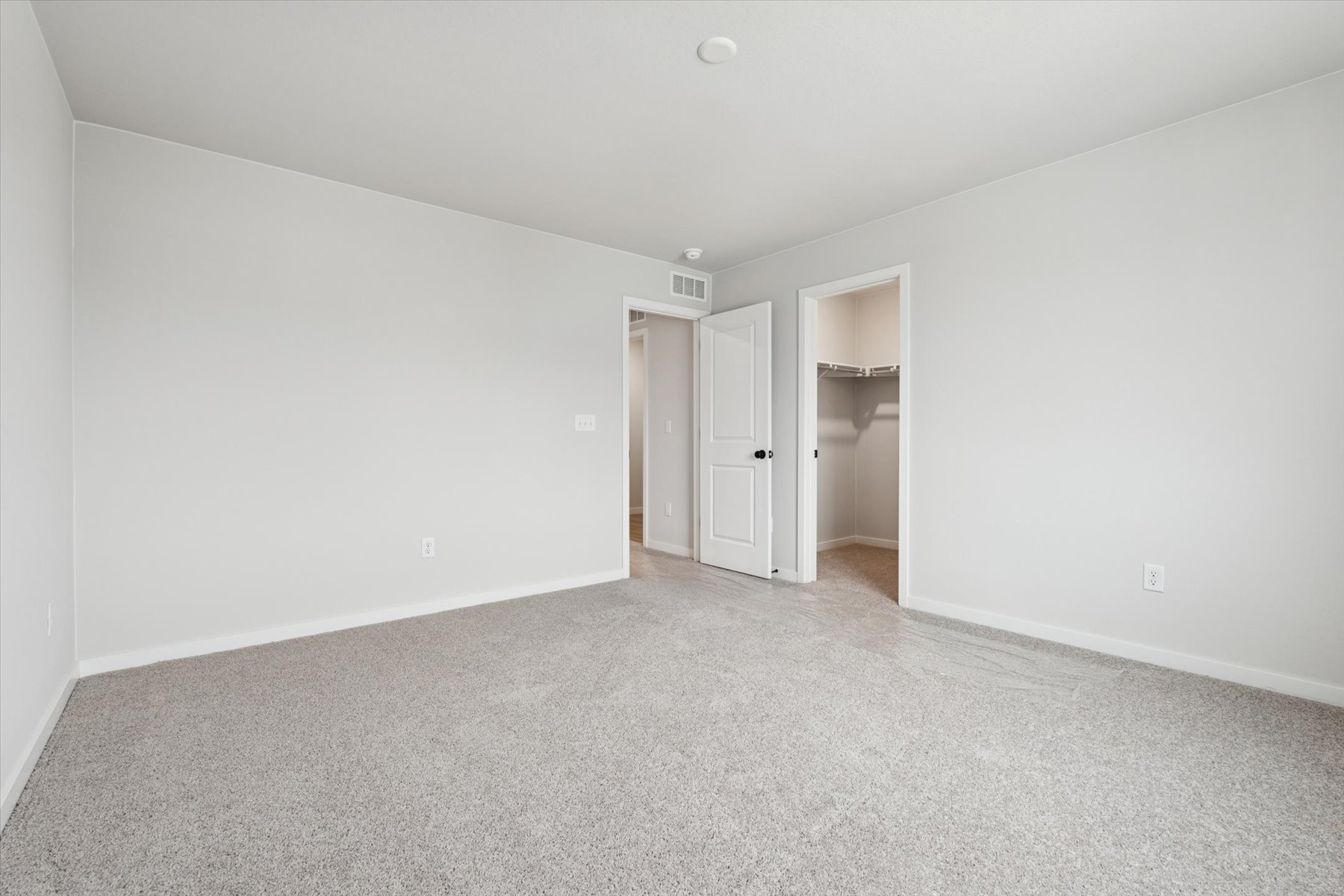 A hallway with white walls.