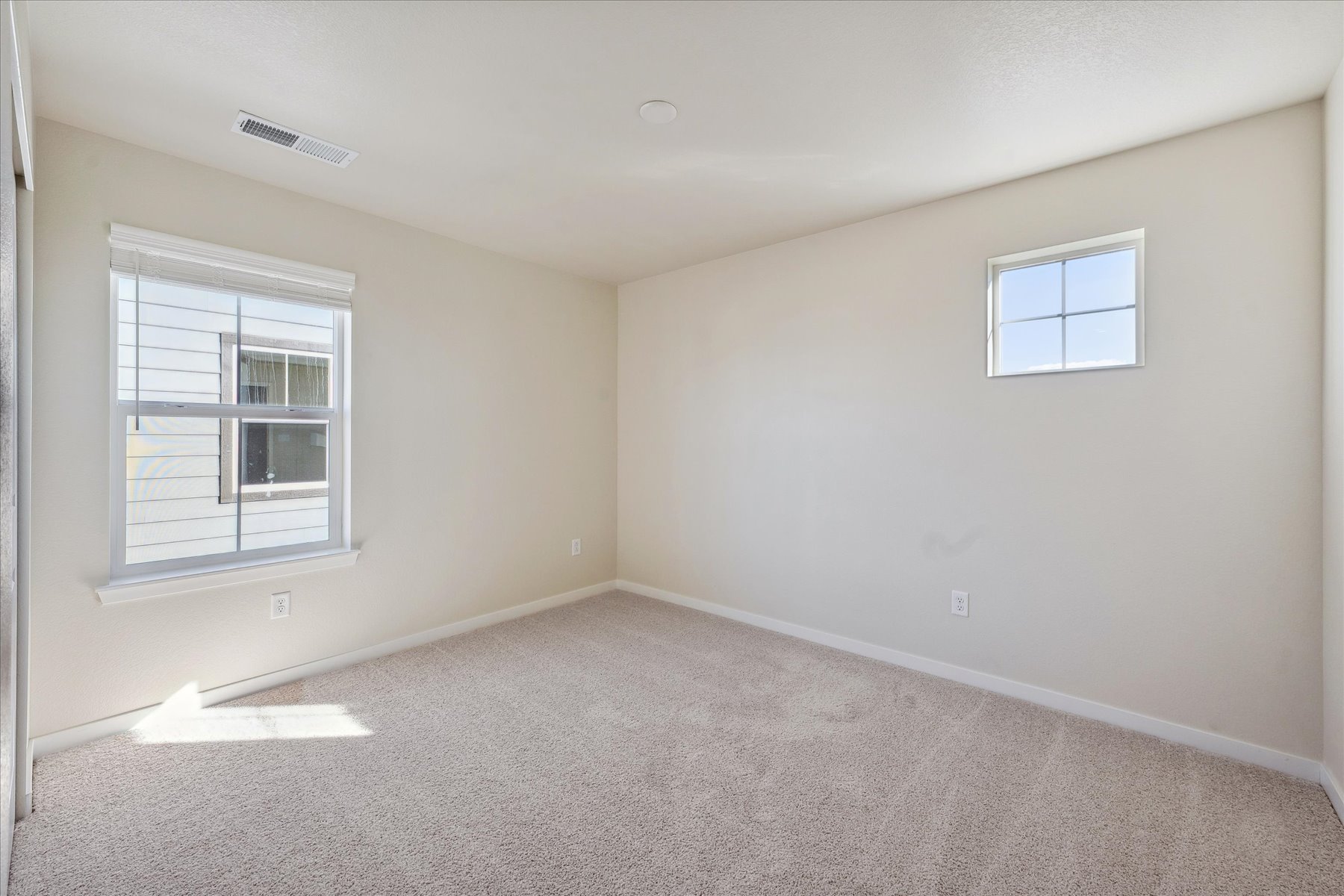 A room with a window and a carpet.
