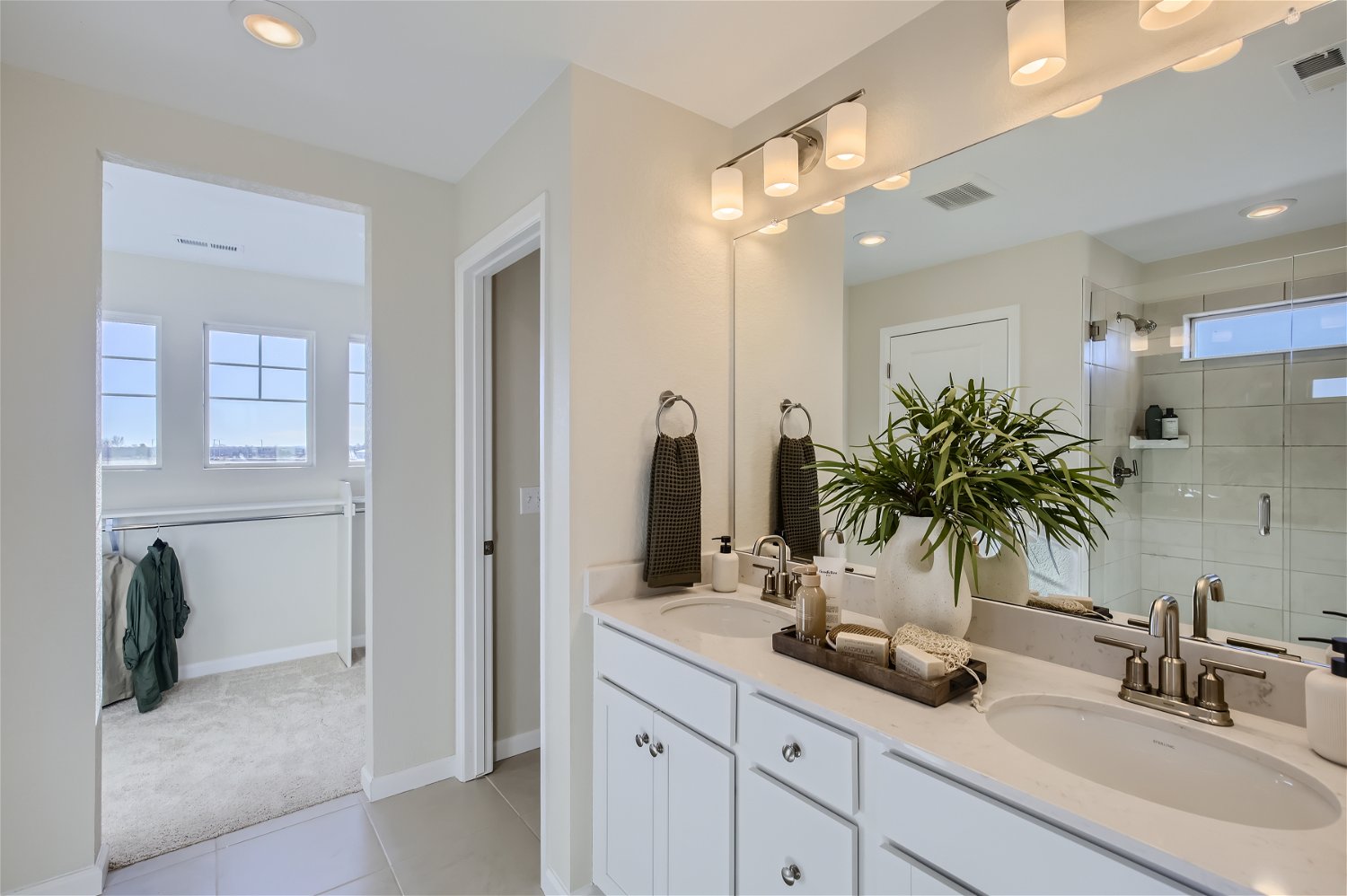 A bathroom with a large mirror.