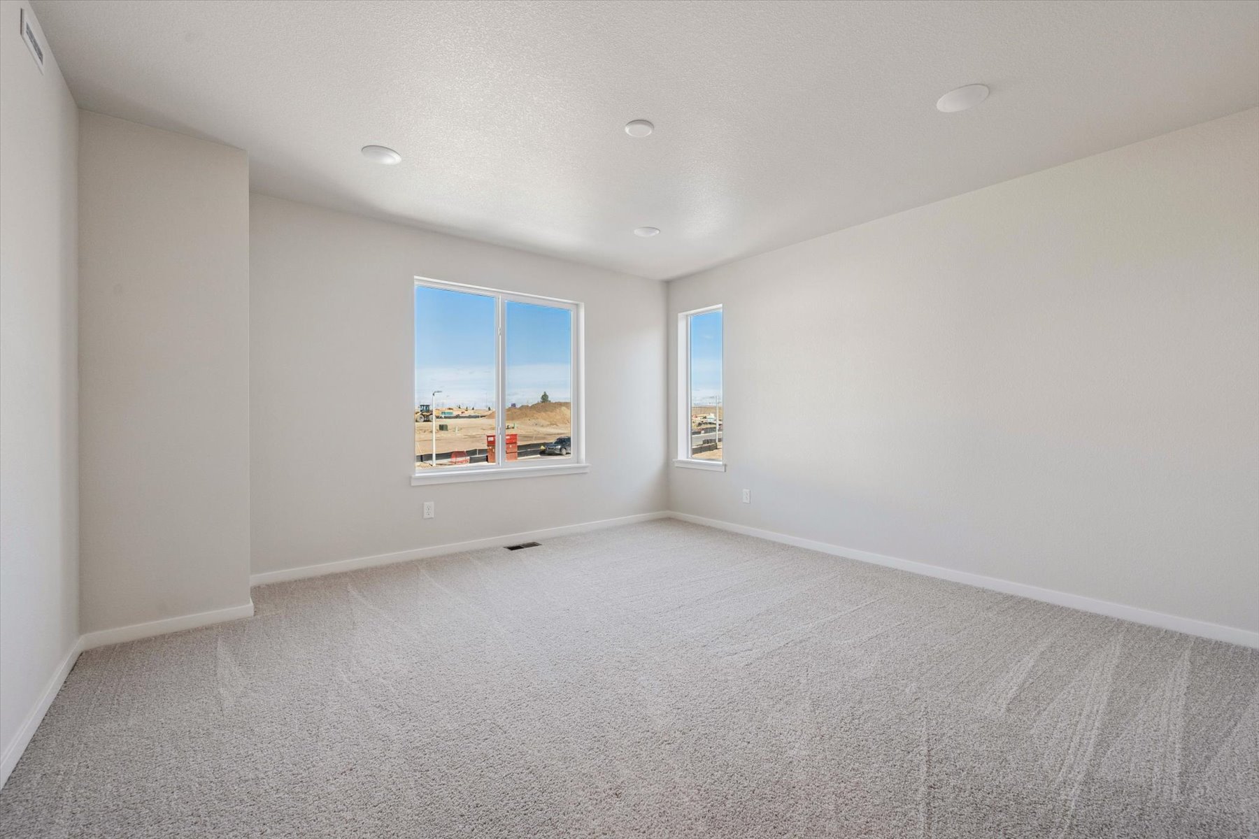 A room with a window and a carpet.