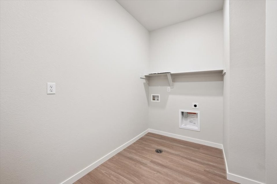 A room with a wood floor and white walls.
