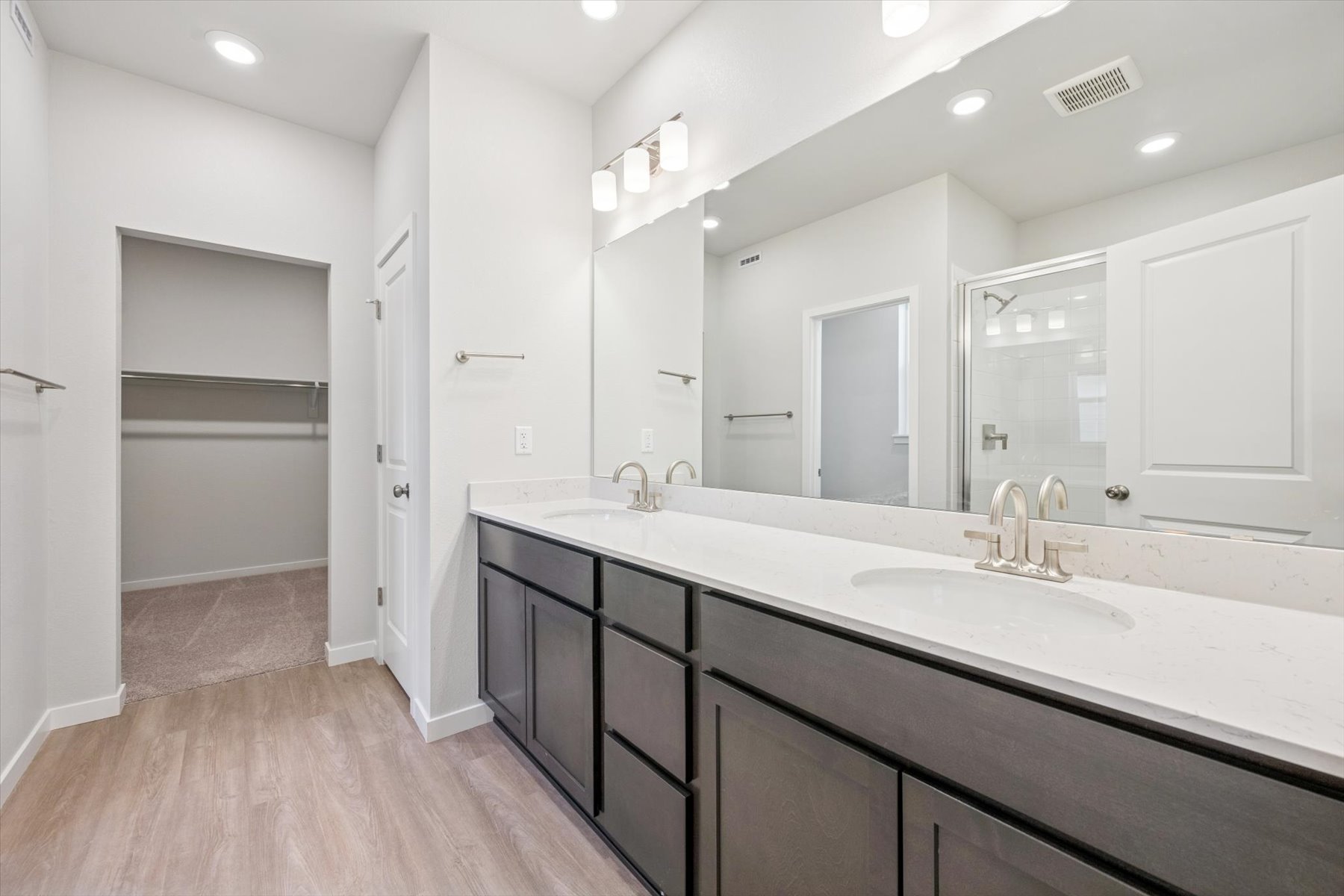 A bathroom with a large mirror.