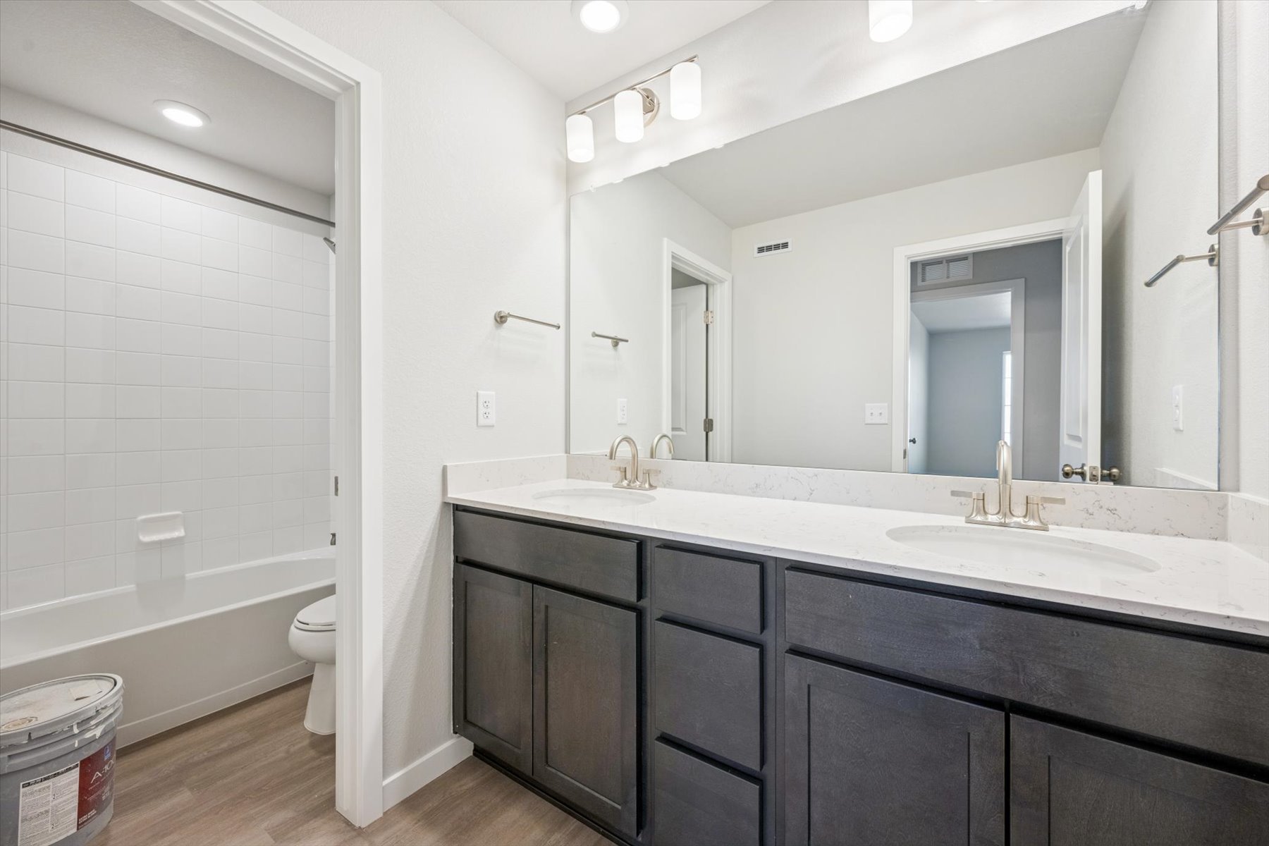 A bathroom with a tub sink and toilet.